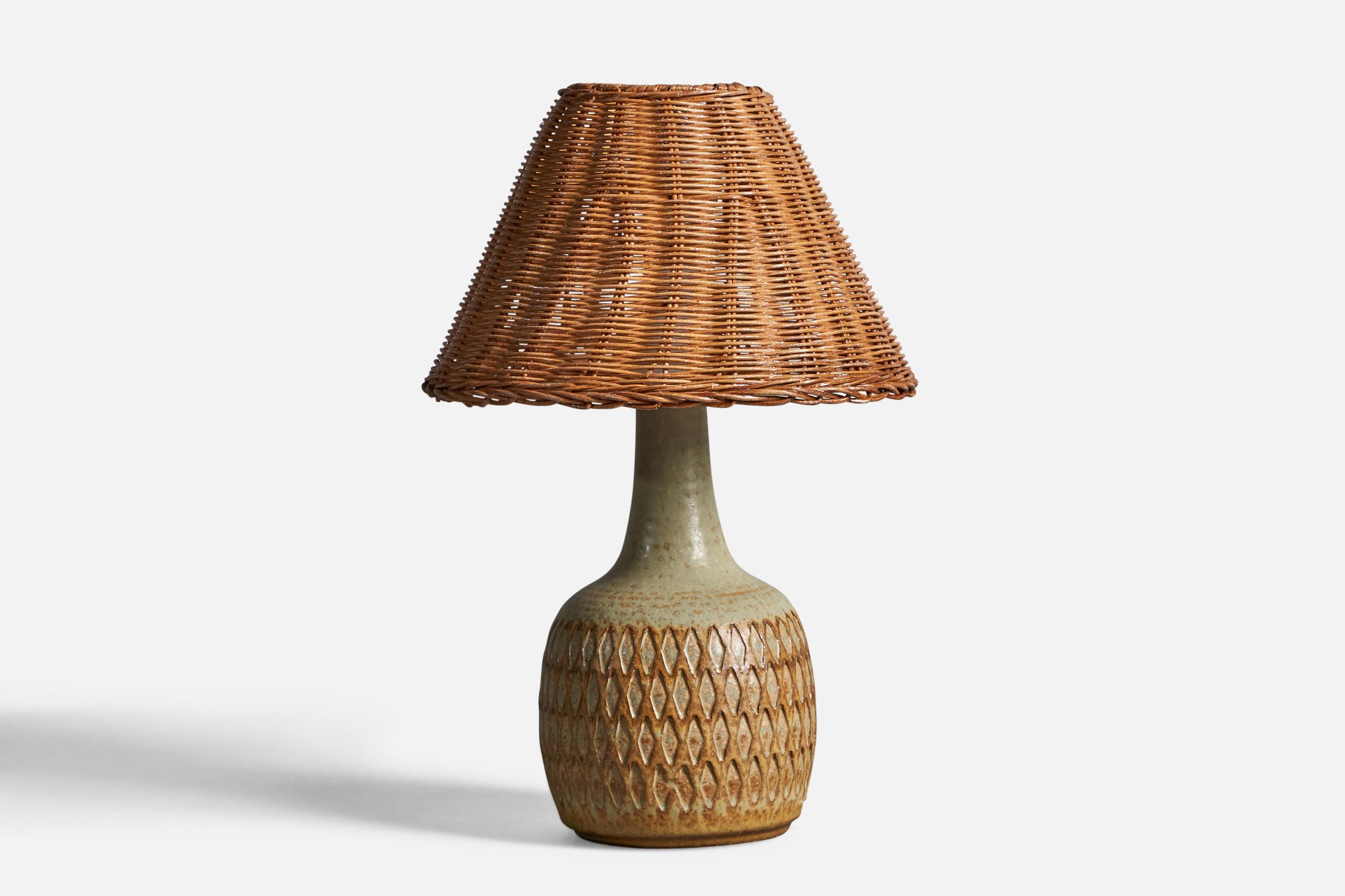 A green and brown-glazed incised stoneware and rattan table lamp, designed and produced in Denmark, 1960s.

Overall Dimensions (inches): 13