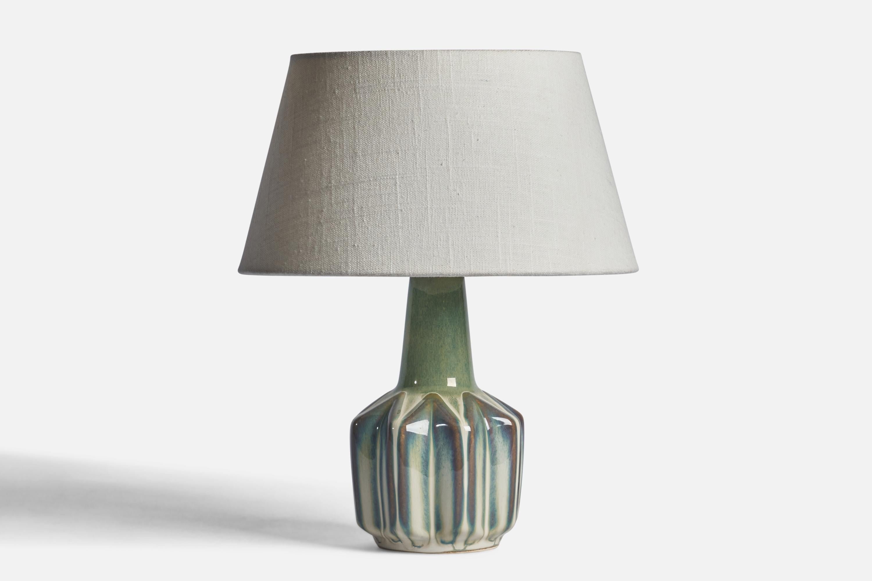 A green-glazed stoneware table lamp designed and produced by Søholm, Bornholm, Denmark, 1960s.

Dimensions of Lamp (inches): 9.35” H x 4.25” Diameter
Dimensions of Shade (inches): 7” Top Diameter x 10” Bottom Diameter x 5.5” H 
Dimensions of Lamp
