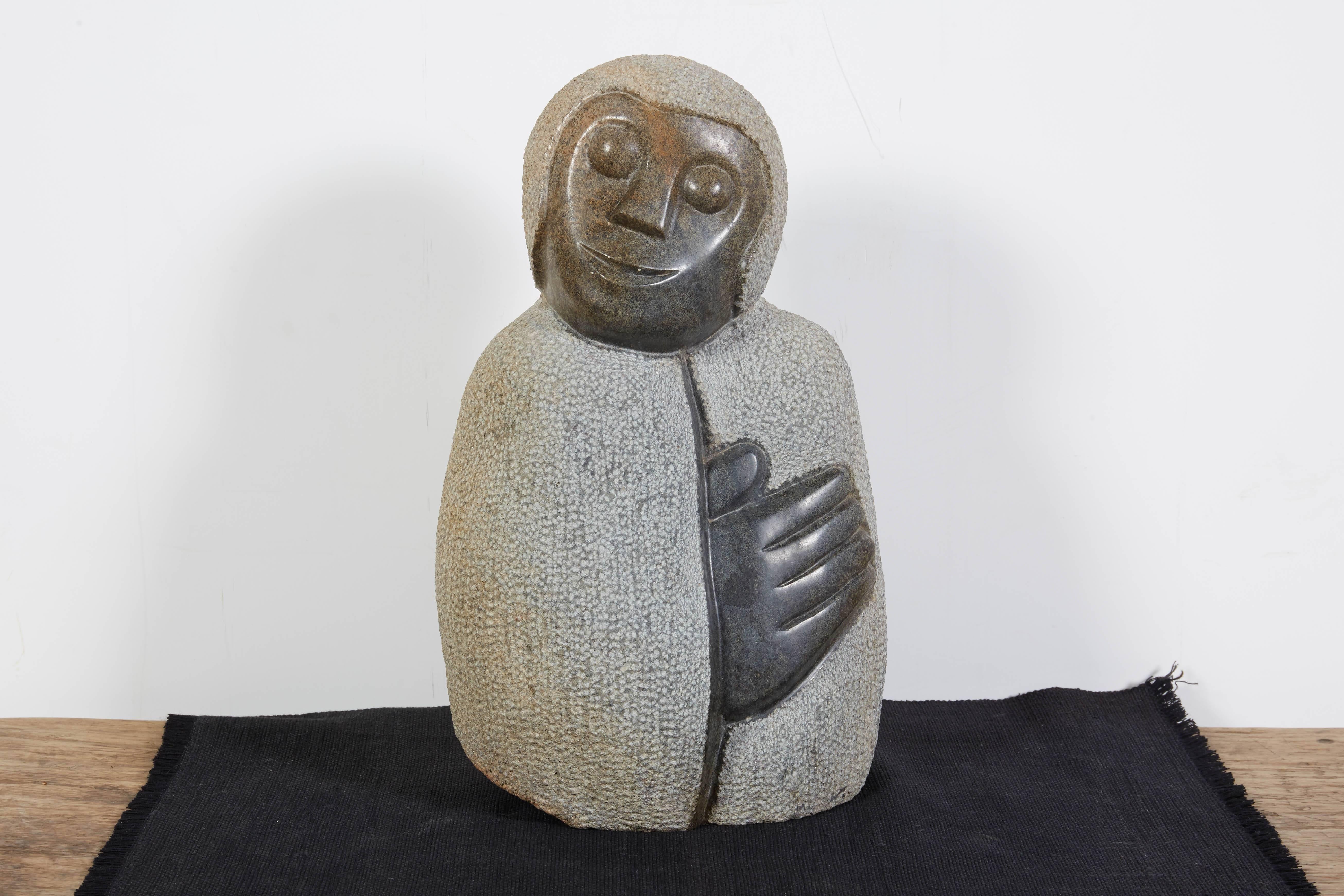 A sensitively carved stone sculpture from Zimbabwe by Shona artist Netsai Mukomberanwa
depicting a lovely image of a caring mother with her hand placed gently over her heart. This carving is striking and touching from every angle. See additional
