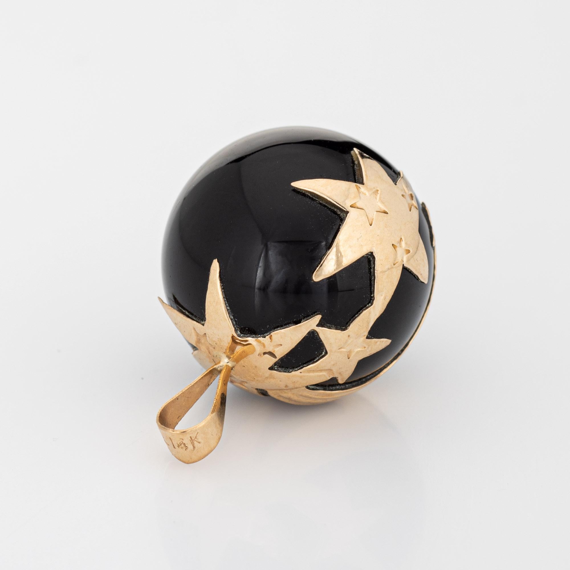 Finely detailed vintage shooting star onyx pendant crafted in 14k yellow gold (circa 1970s).  

The unique pendant features a shooting star pattern rendered in 14k yellow gold, set upon the onyx orb. The bale measures 3mm and can accommodate a thin