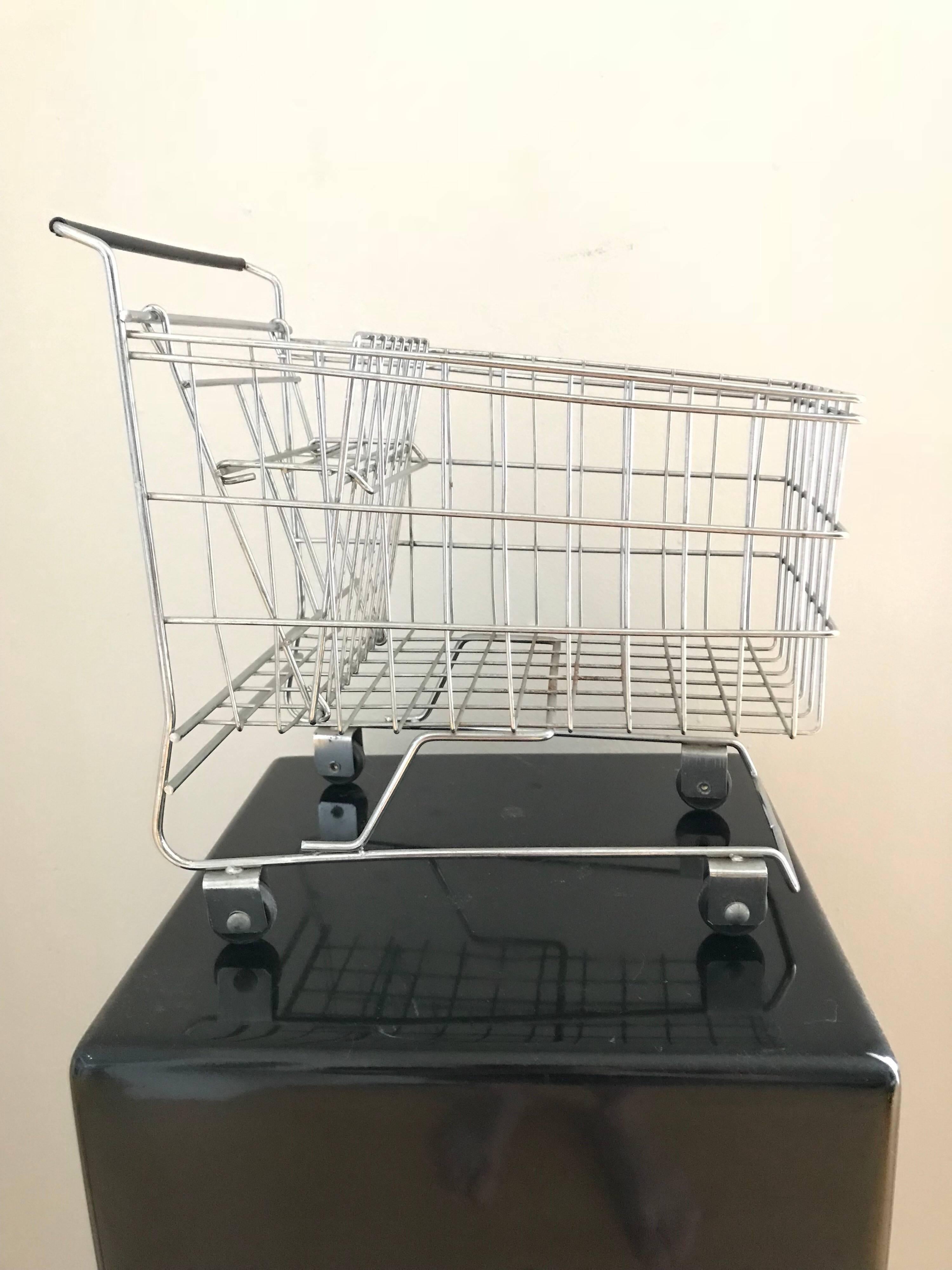 Miniature shopping cart sculpture.