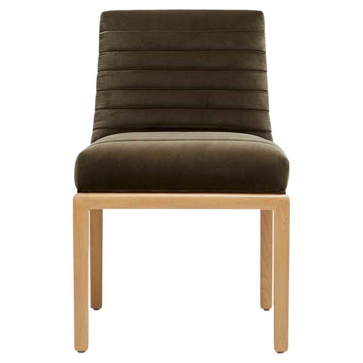 The Shoreland chair is part of the collaborative collection with interior designer Brian Paquette. The dining chair features a channel tufted back and seat with a solid American walnut or white oak frame. This piece is available in exclusive BP for