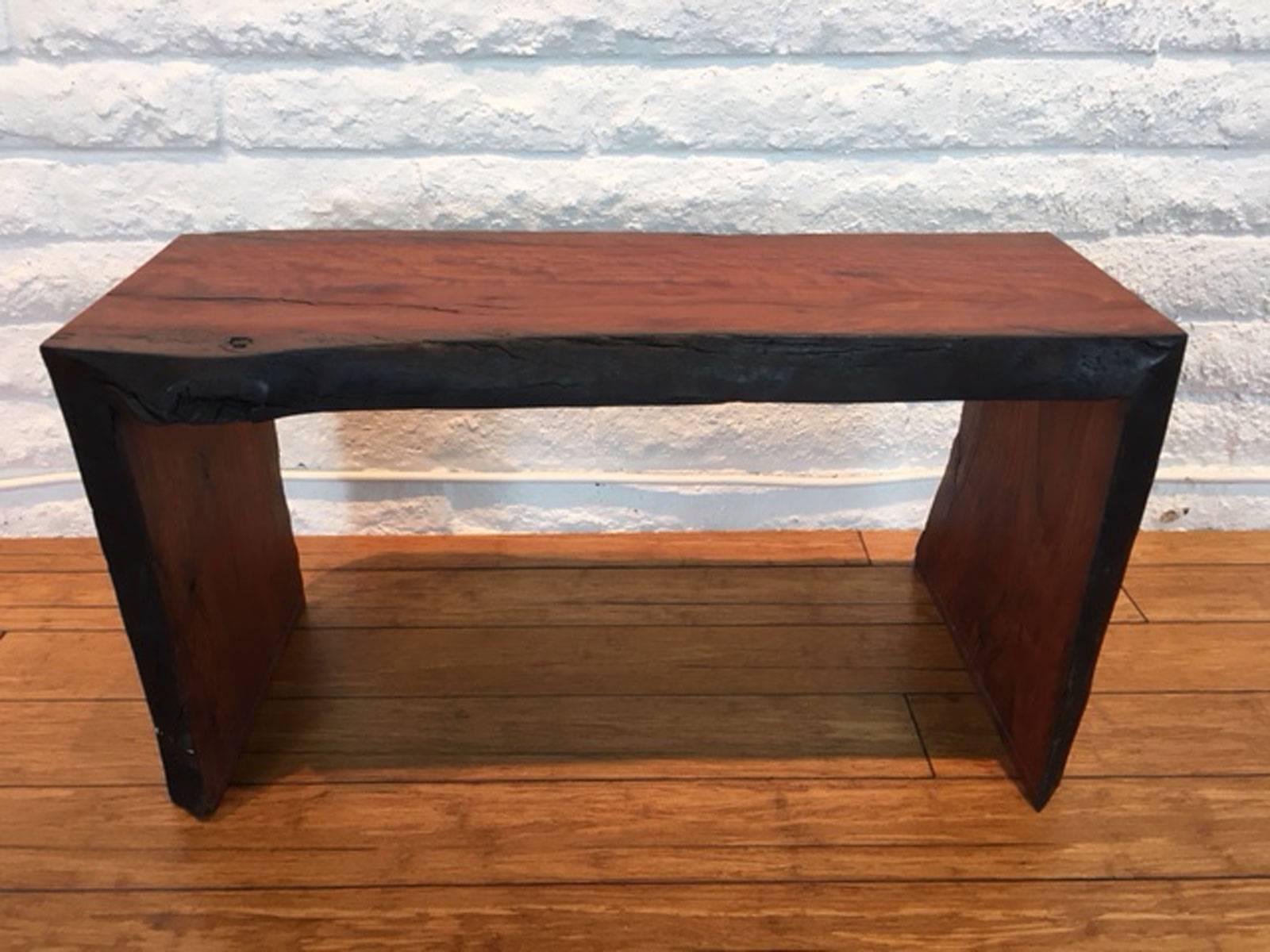 Short eucalyptus wood bench designed, produced and made by master wood artist and designer Scott Mills who only uses reclaimed (deadfall or storm downed trees) in the pieces he designs and produces. Appropriate for home or commercial use. No veneer.