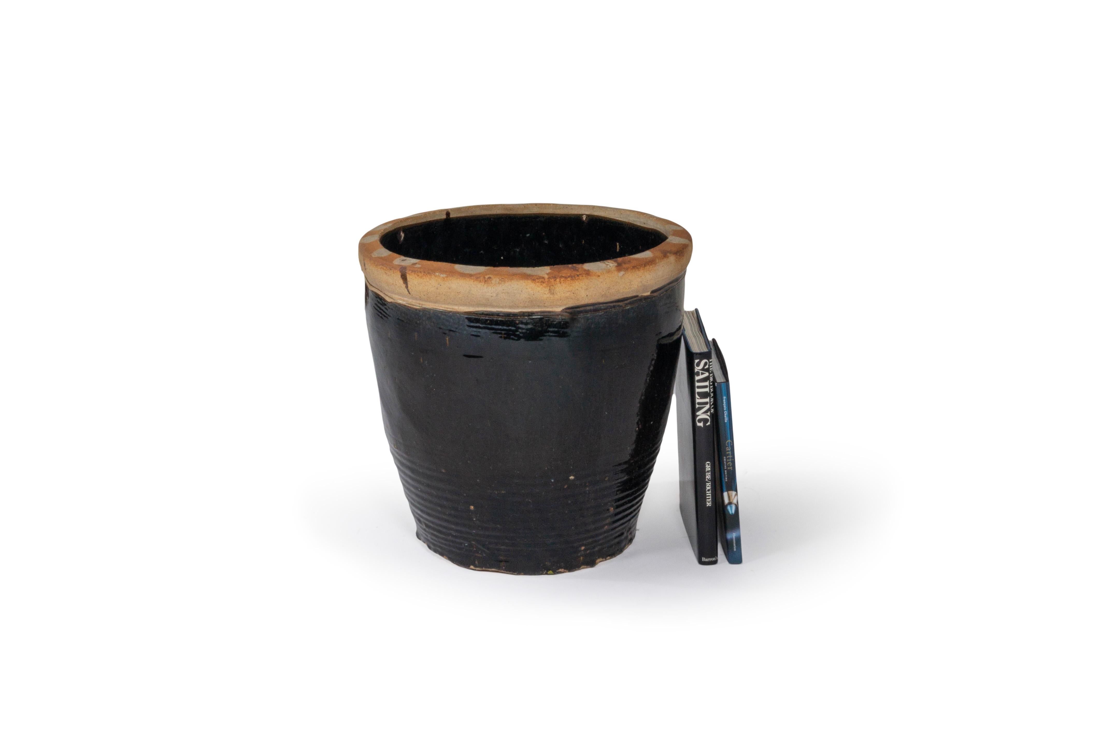 This terra cotta storage vase features a beautiful dark brown glaze which adds beautiful contrast to your garden. 

This piece is a part of Brendan Bass’s one-of-a-kind collection, Le Monde. French for “The World”, the Le Monde collection is made