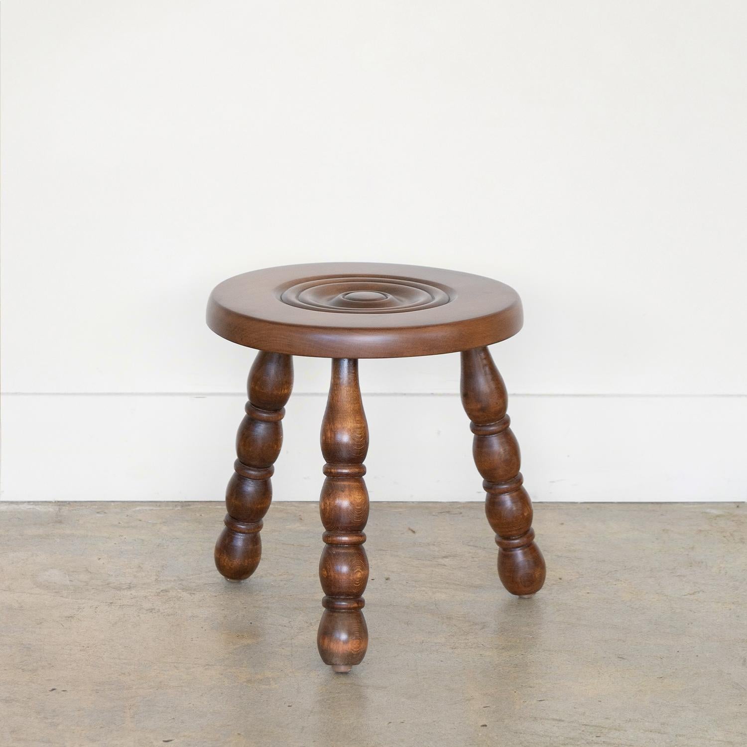 Vintage short wood stool with beautiful chunky carved wood legs from France. Circular seat with carved ring detail on top. Newly refinished in a medium stain. Can be used as stool or as side table next to chairs. 

