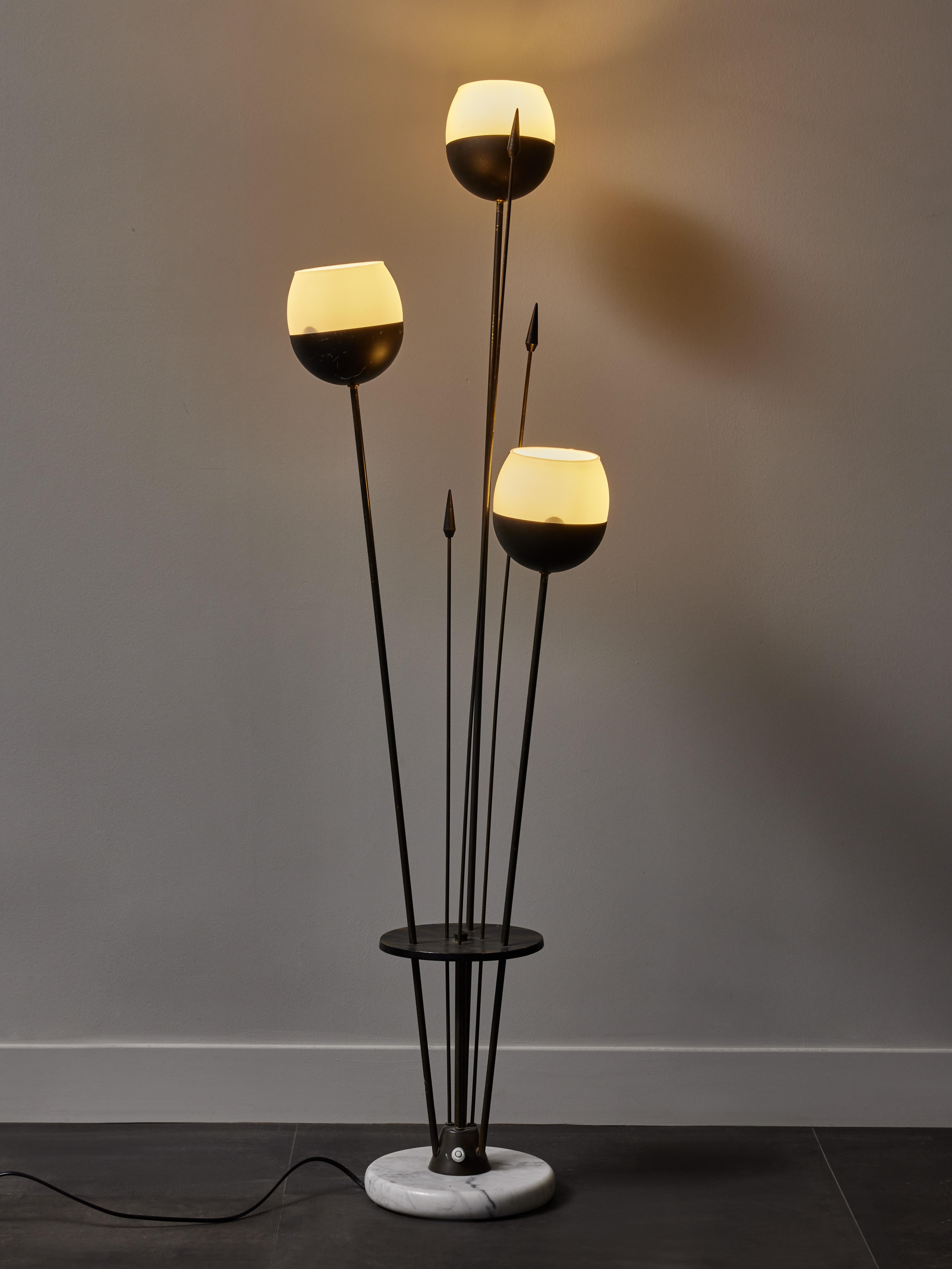 Small floor lamp made of a round marble base, three arms of light of different height topped with half globes opaline glasses, and metal decorative spears.