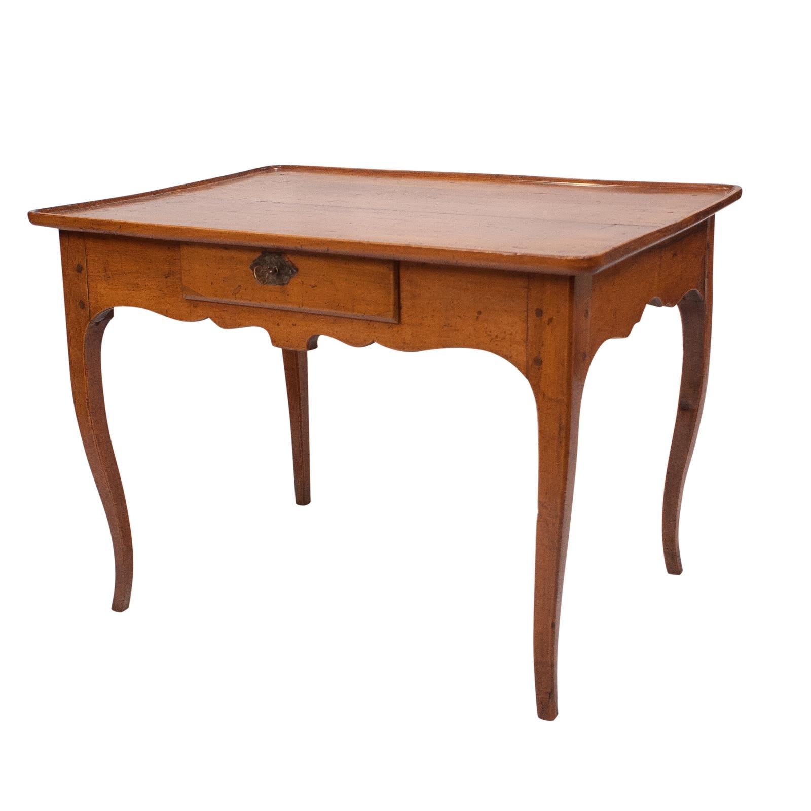 A short late 18th early 19th century French cherry one drawer table, circa 1800. Graceful small one drawer dish topped rectangular table. Perfect size for a coffee table. 

