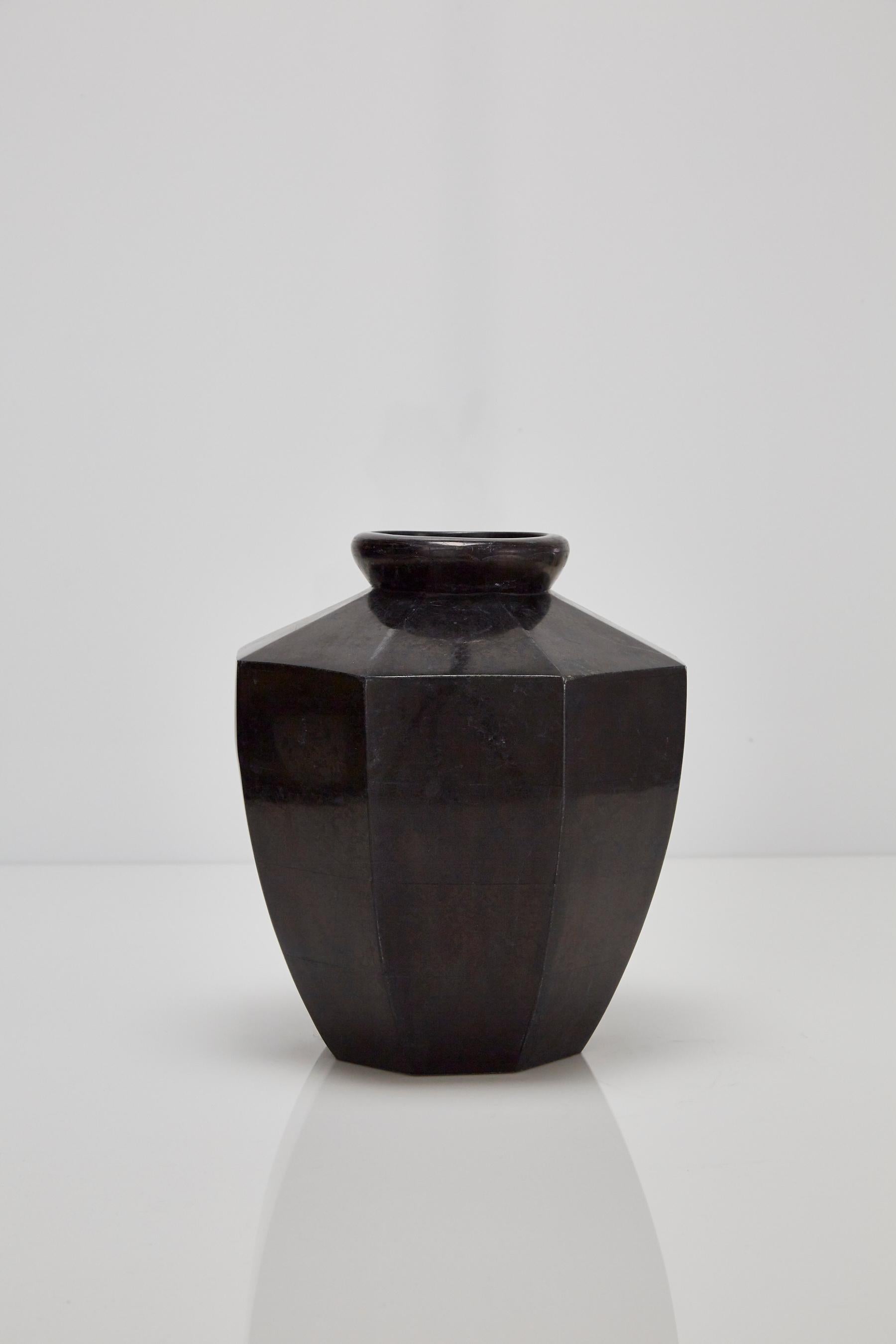 Short octagon flower vase executed in tessellated black stone over a fiberglass body.

All furnishings are made from 100% natural Fossil Stone or Seashell inlay, carefully hand cut and crafted piece-by-piece and precisely inlaid to the form of the