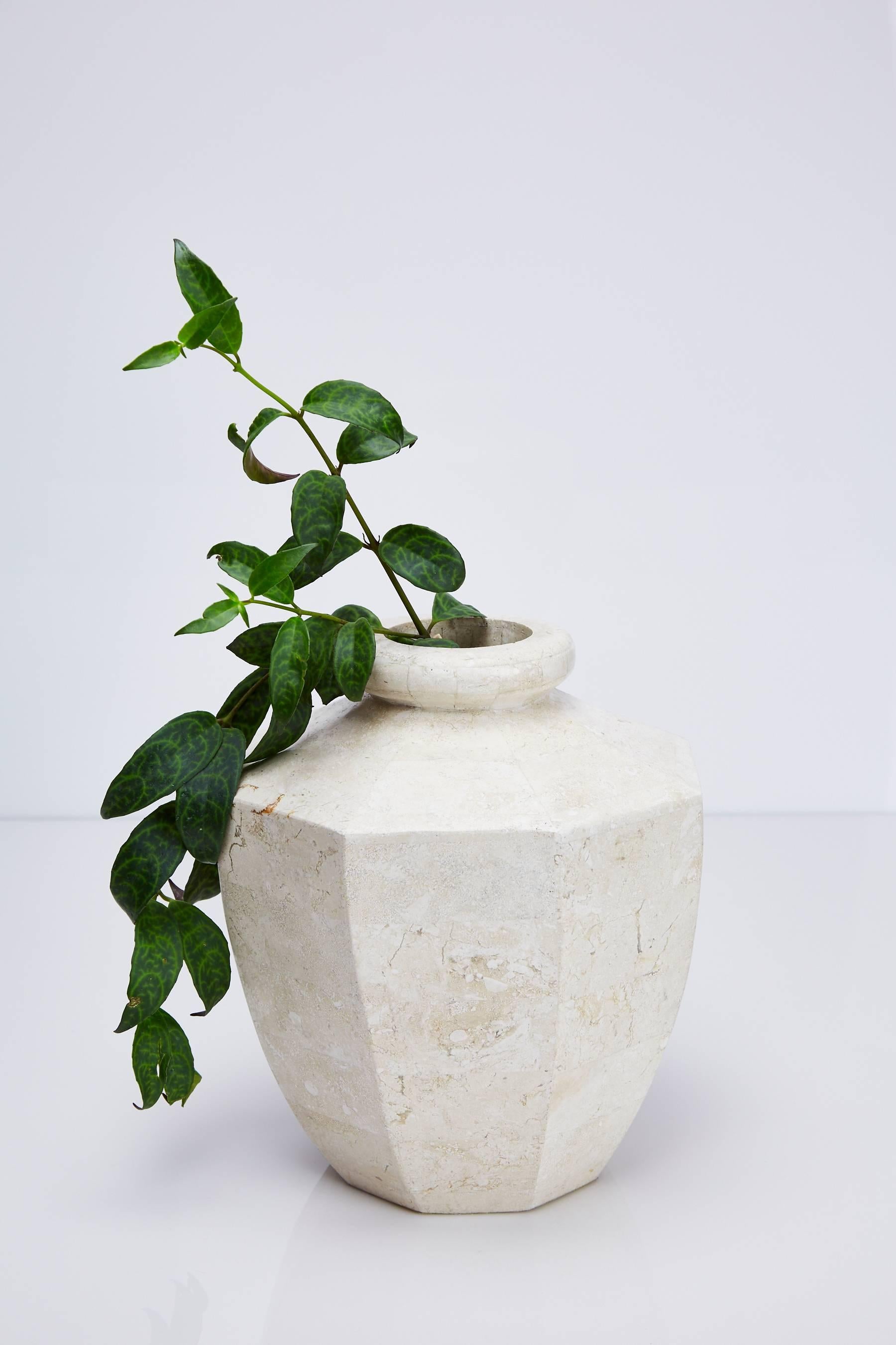 Short octagon flower vase executed in tessellated white ivory stone over a fiberglass body.