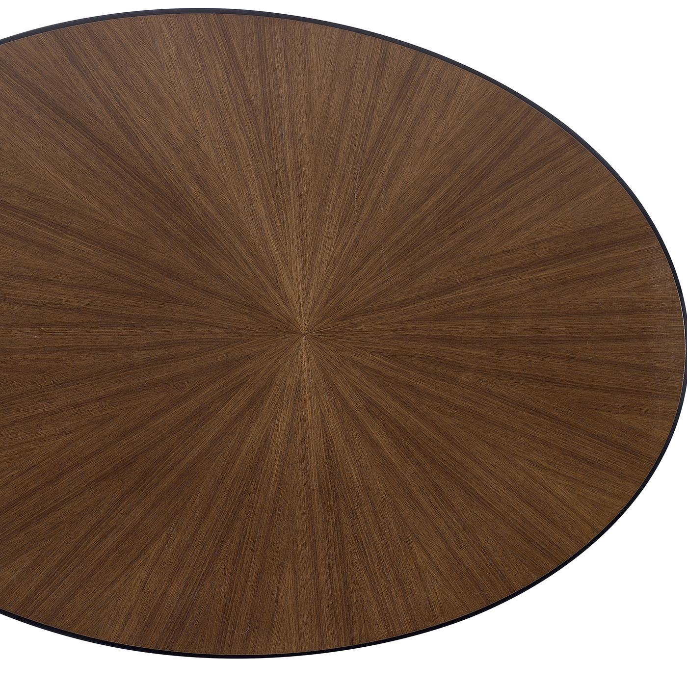 An eclectic and versatile piece of functional decor, this short coffee table boasts a symmetric silhouette marked by an oval base and an oval top. The structure is crafted of open-pore black lacquered plywood and ash-veneered MDF and is enriched