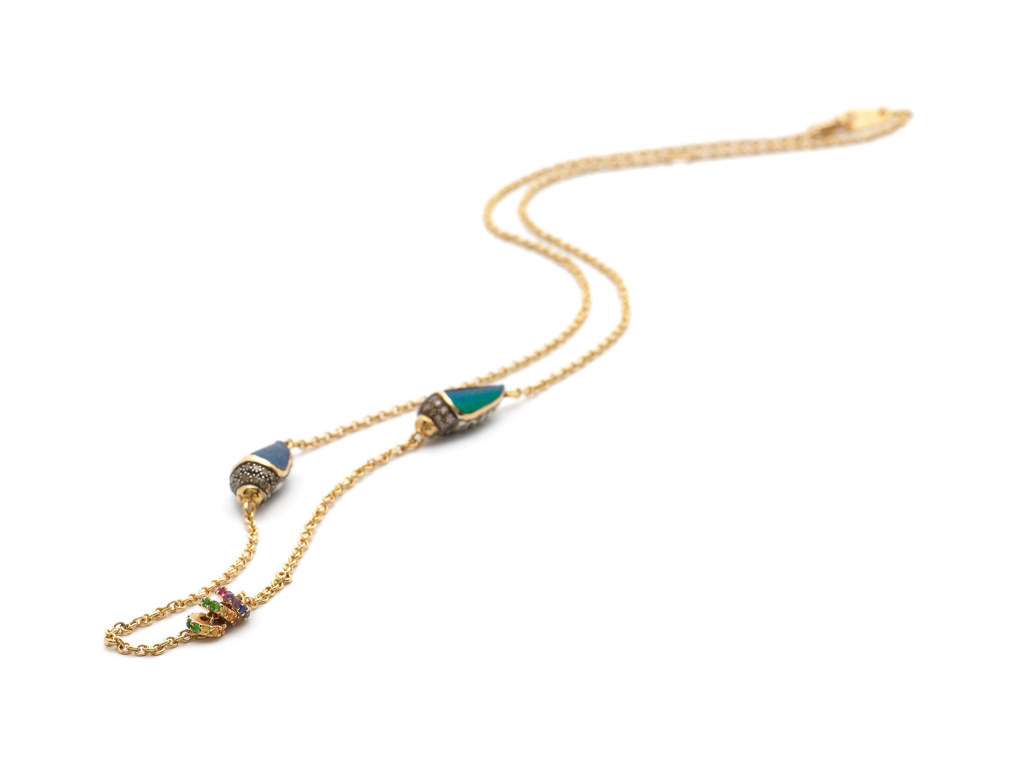 

This necklace sits like a second skin on the collarbone. The piece is designed as a fine, 18k yellow gold chain on which sit two sterling silver scarabs, set with real scarab wings and embellished with brown diamonds, tsavorites, and