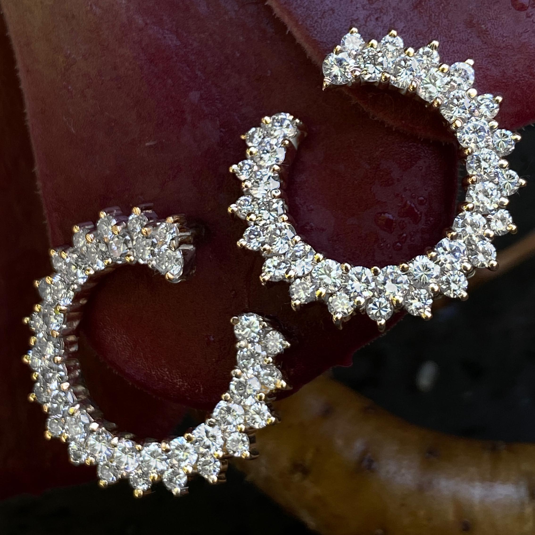 A different take on diamond hoops, these lie flat against the ear and feature two rows of bright white diamonds.  The hoop shape is  torqued a bit so that they 