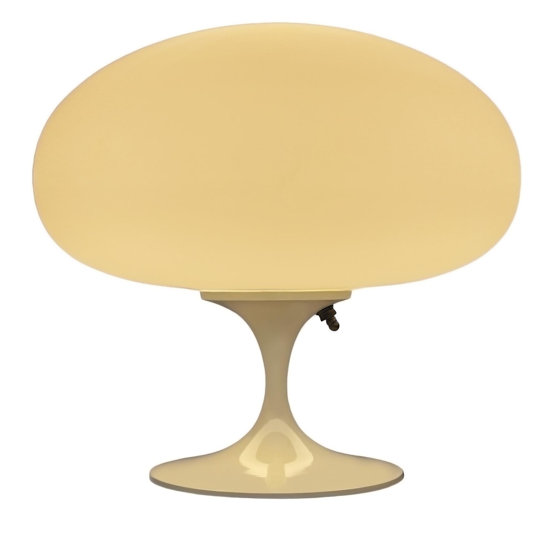 THIS ITEM IS ELIGIBLE FOR FREE SHIPPING!

A sleek stemlite table lamp made by Design Line. It features a cast aluminum main base in a sculptural tulip form. The lamp base is finished in a classic retro beige color. The frosted glass lamp shade is