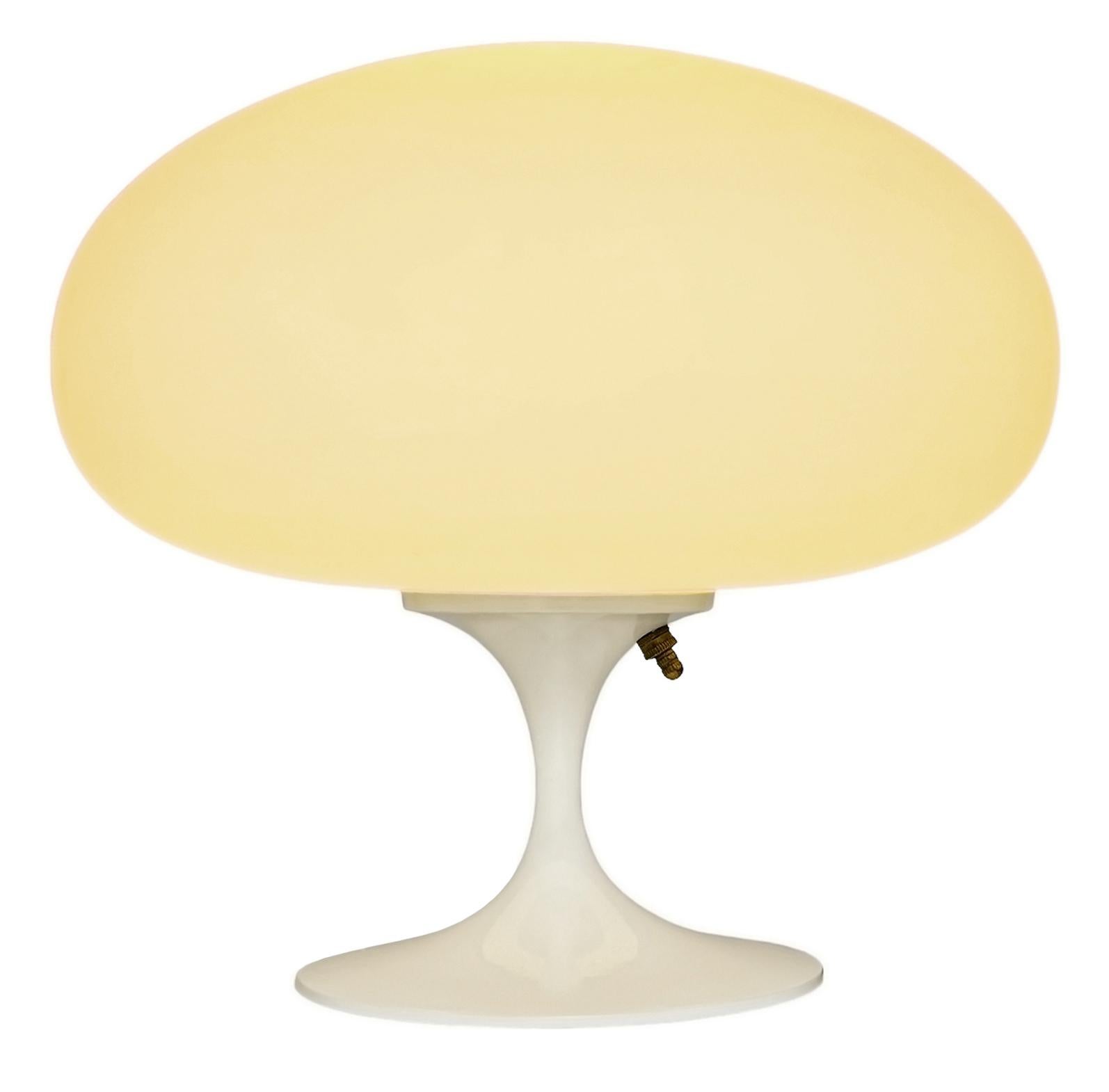 THIS ITEM IS ELIGIBLE FOR FREE SHIPPING!

A sleek stemlite table lamp made by Design Line. It features a cast aluminum main base in a sculptural tulip form. The lamp base is finished in high gloss white. The frosted glass lamp shade is hand blown