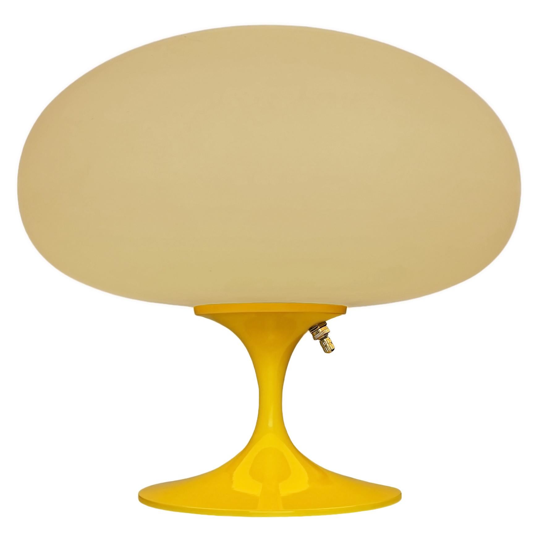 THIS ITEM IS ELIGIBLE FOR FREE SHIPPING!

A sleek stemlite table lamp made by Design Line. It features a cast aluminum main base in a sculptural tulip form. The lamp base is finished in a classic bright lemon yellow color. The frosted glass lamp