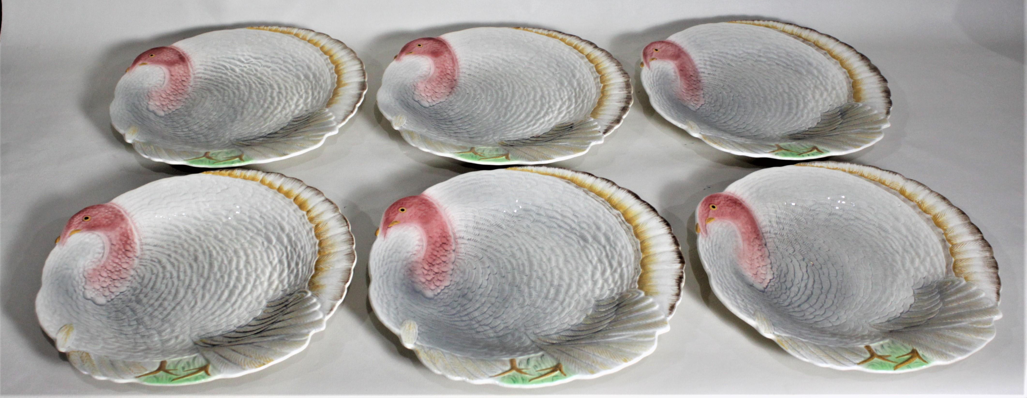 This turkey serving set is made up of a very large platter and a set of six matches serving plates made by Shorter and Sons of Staffordshire England in circa 1950. The large platter features a colorful and stylized turkey done in vibrant tones and a