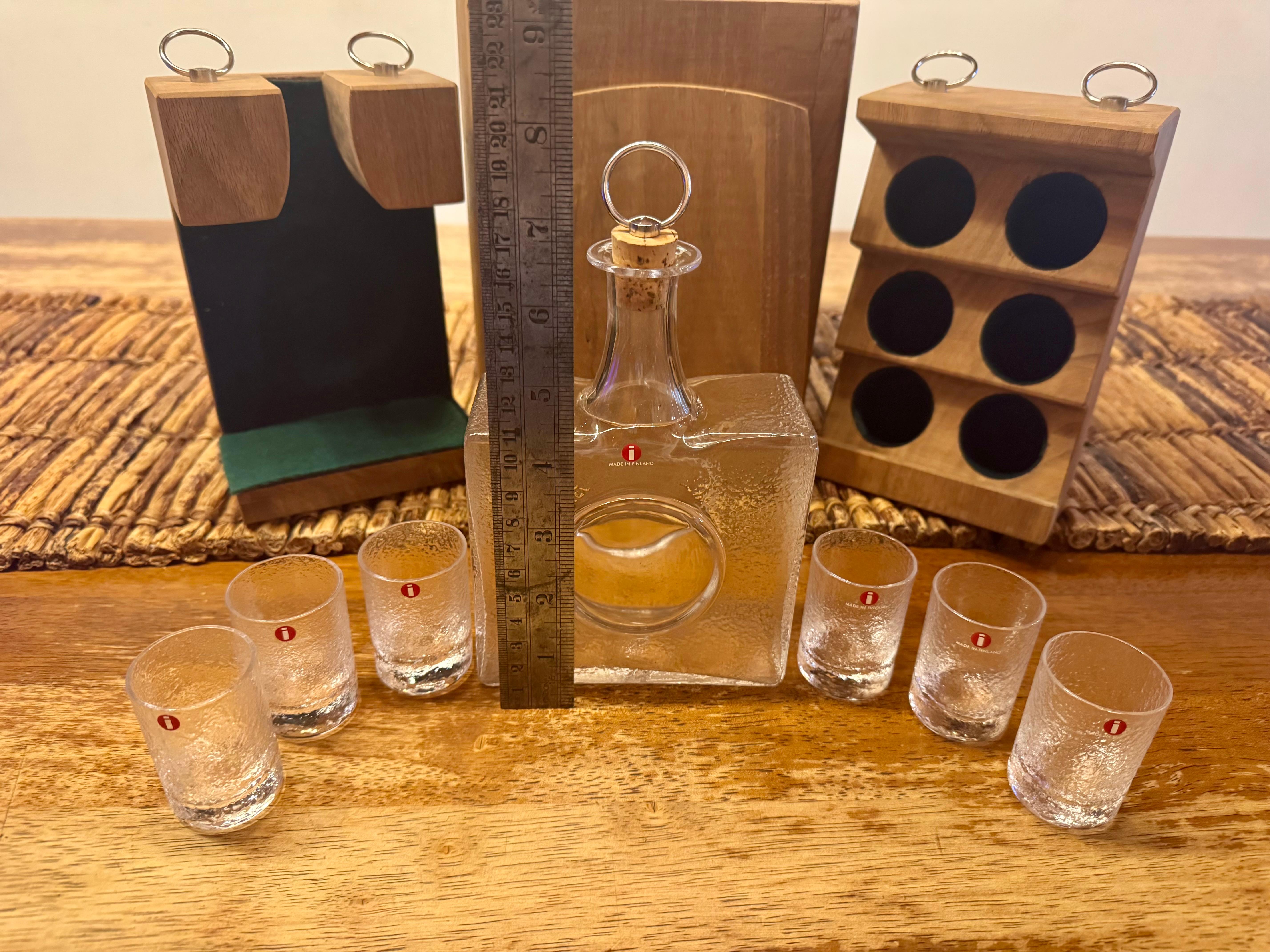 Shot Set Designed by Tapio Wirkkala for Iittala
A bottle and six glasses presented in a fine oak case. A rare collector’s set.
The glasses are approximately 5.5 cm tall with a diameter of 3.5 cm.
The bottle measures approximately 17 cm in height,
