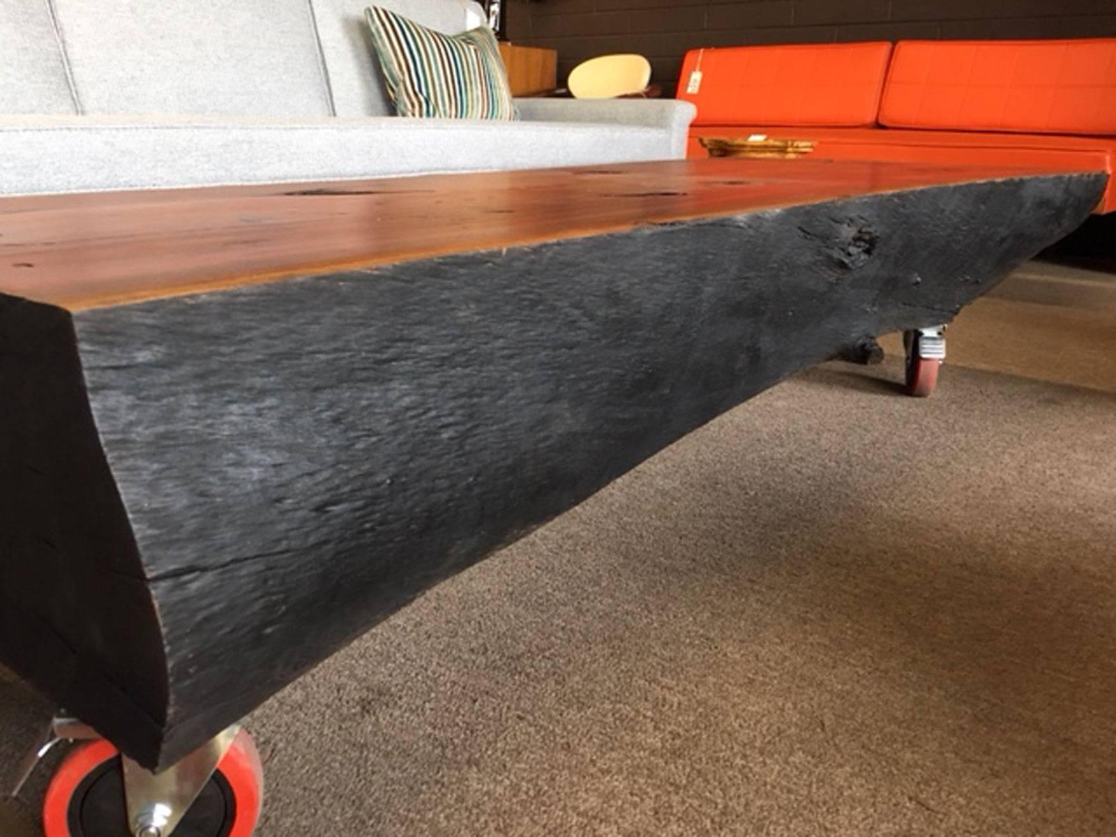 Eye-catching eucalyptus wood coffee table utilizing the traditional Japanese tradition of shou-sugi-ban, a wood burning technique consisting of charring the wood, cooling it, cleaning it, and applying oil. The charred surface is stylish and clean. 