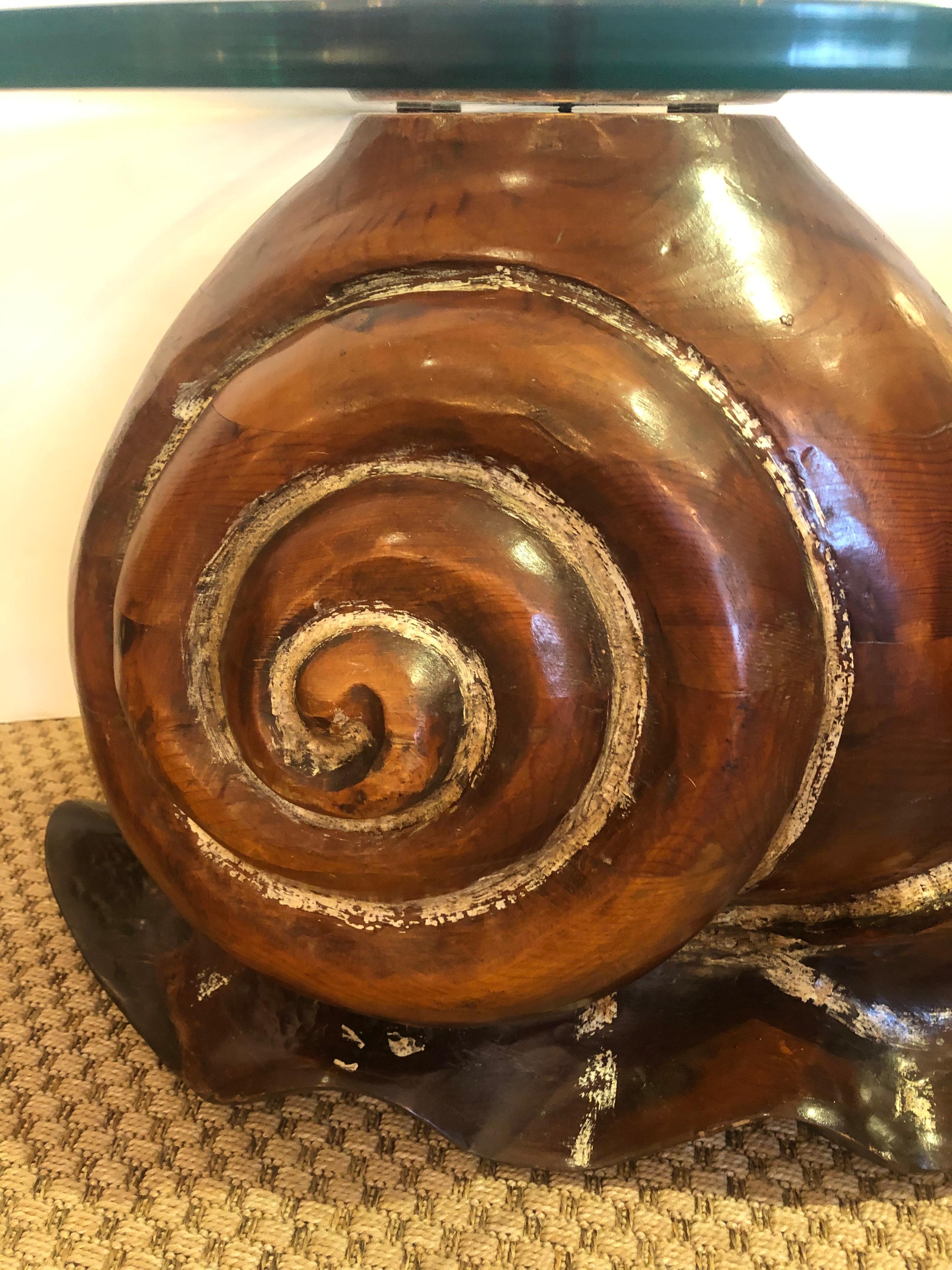Super stylish whimsical cocktail or side table having rich carved wood sculptural snail shaped base with 1/2