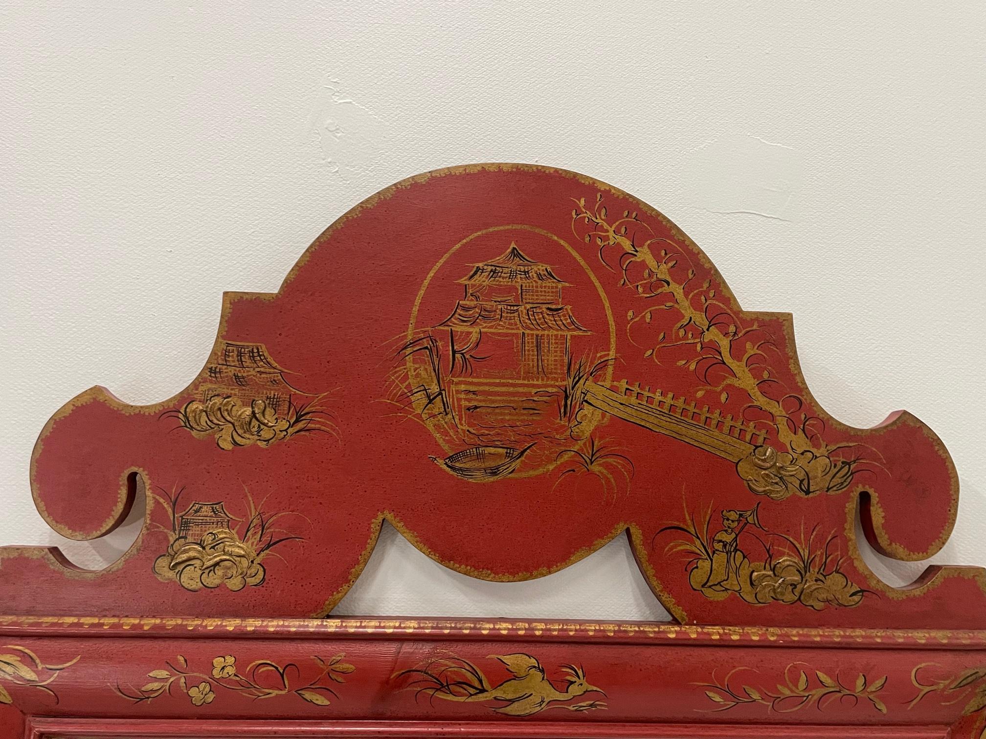 Glamorous large lucky red Italian mirror having gold chinoiserie painted decoration and pagoda-esque top.