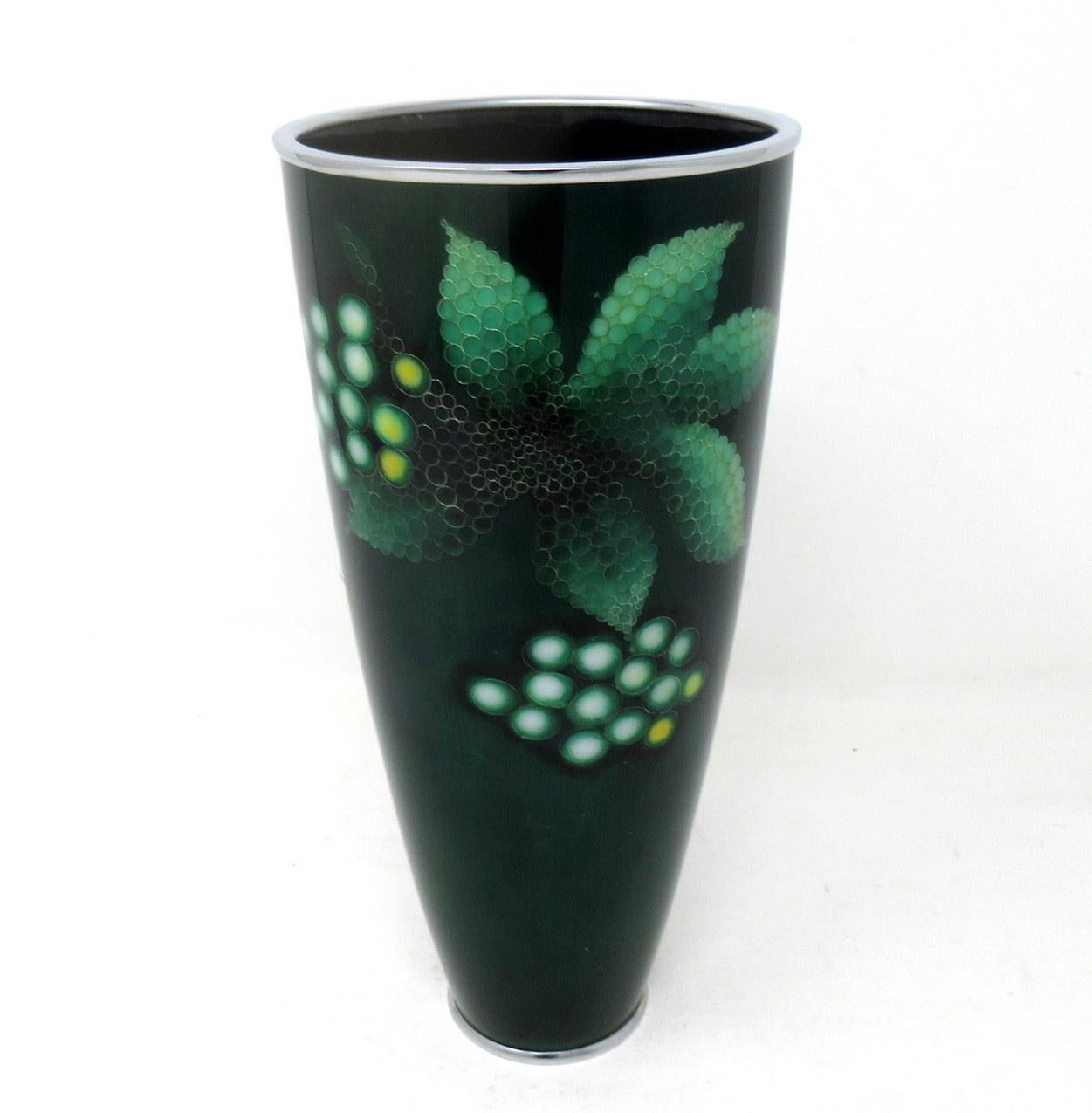 A rare and exceptional Japanese mid Showa period flower vase of beaker outline, by Ando Jubei a Japanese Cloisonné artist from Nagoyo, mid-20th century

The copper body with a mounted silver top rim and base plate. The dark olive green ground is