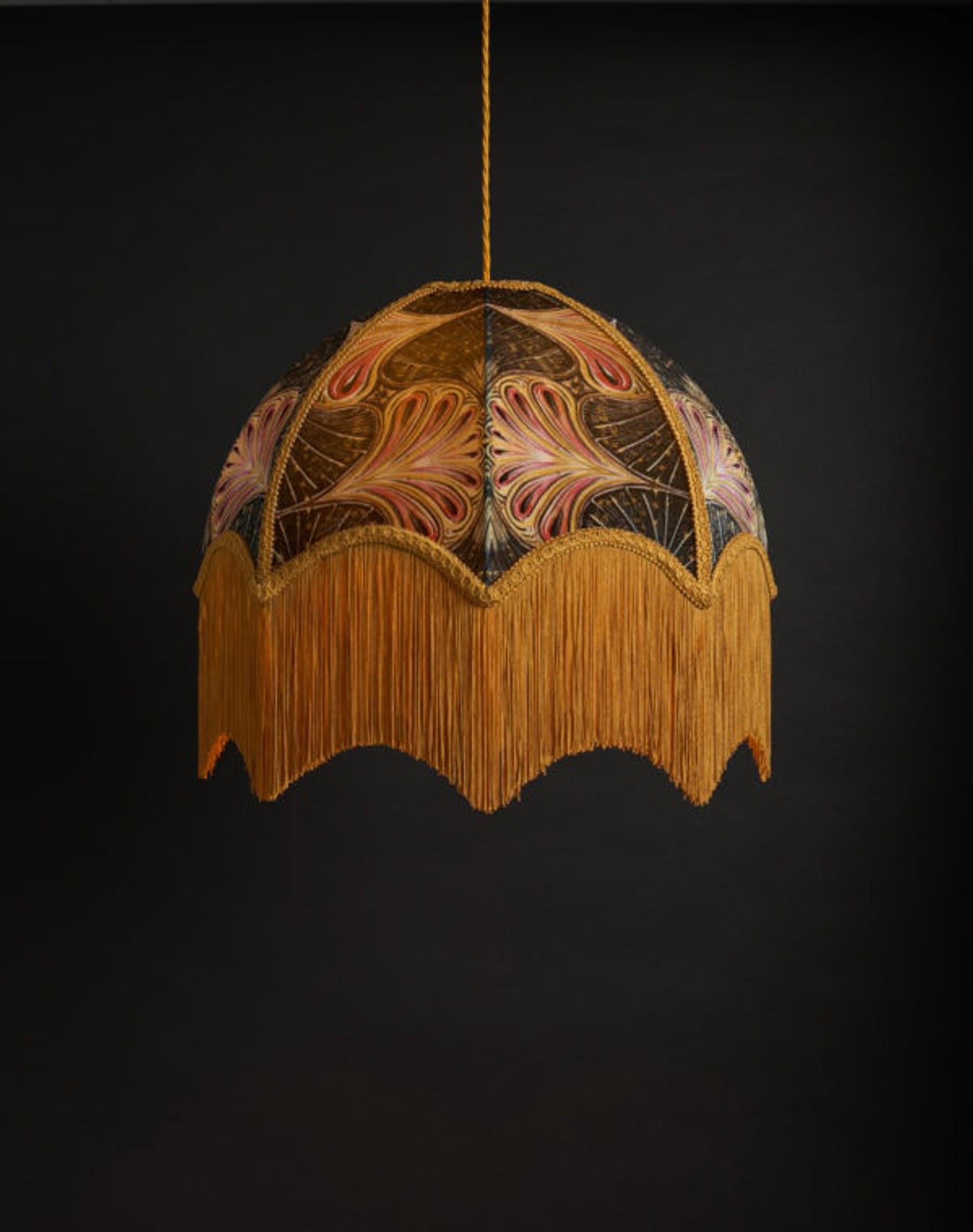 Showgirl is a glamorous fan-like design, produced using cut and painted lino which creates the depth in this pattern of Anna’s, in tones of black, gold and vivid pink.

Anna Hayman lampshades create a fantastic centrepiece to a room and work as well