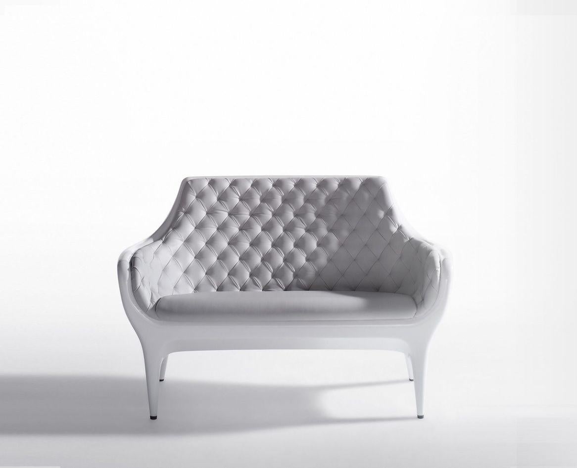 Showtime sofa
Dimensions: D 73 x W 145 x H 95 cm 
Materials: Armchair, sofa, and cover in rotomoulded polyethylene. Upholstered in leather capitoné and bright lacquered.
Available upholstered in different fabrics, lacquered in Black or White, and