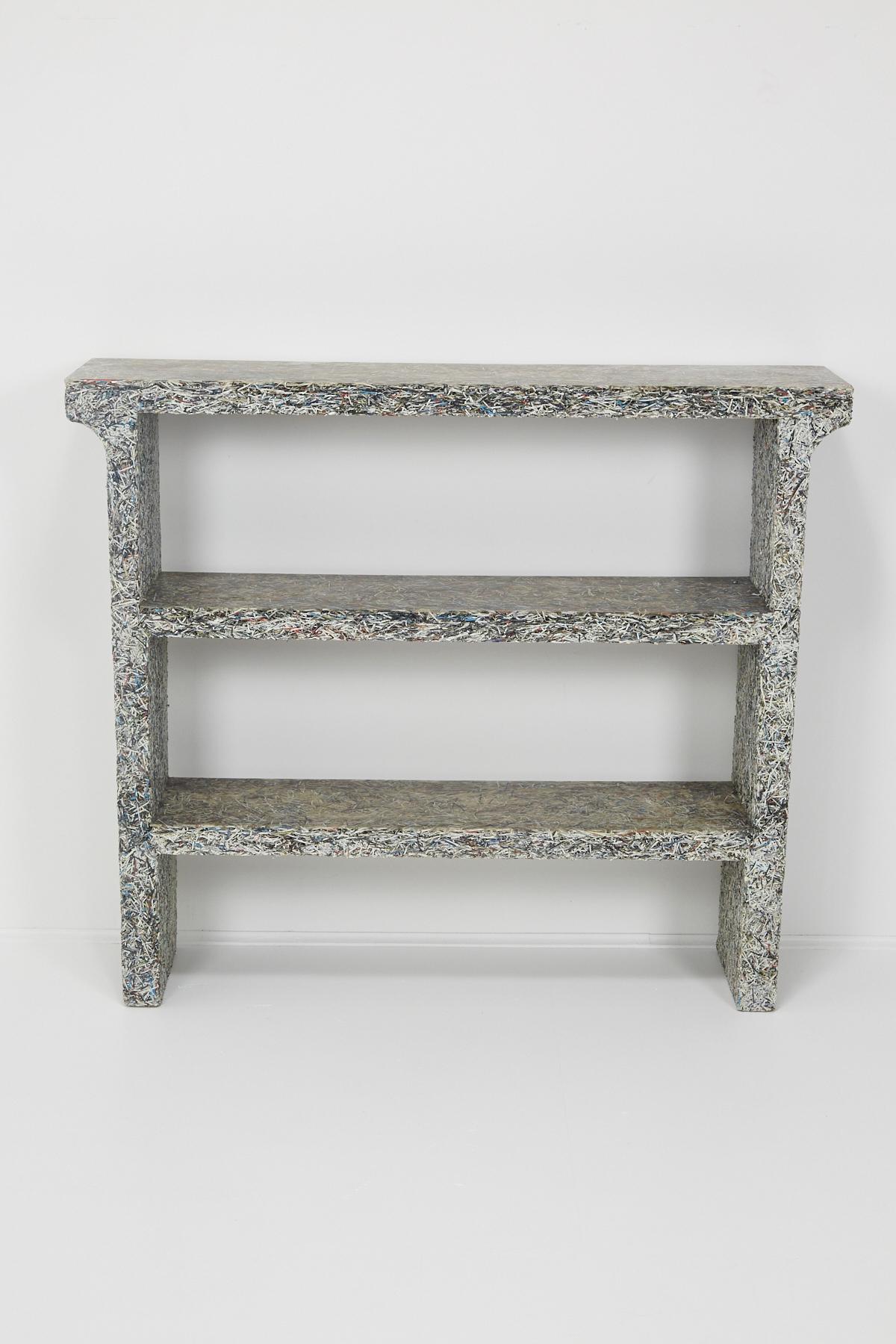 This short bookcase by Belgian-born, Florence-based designer Jens Praet is comprised of shredded Elle Decor magazines. From an edition of 8 and 2APs.

From the artist's website: Arising in reaction to the tremendous amount of office wastepaper,