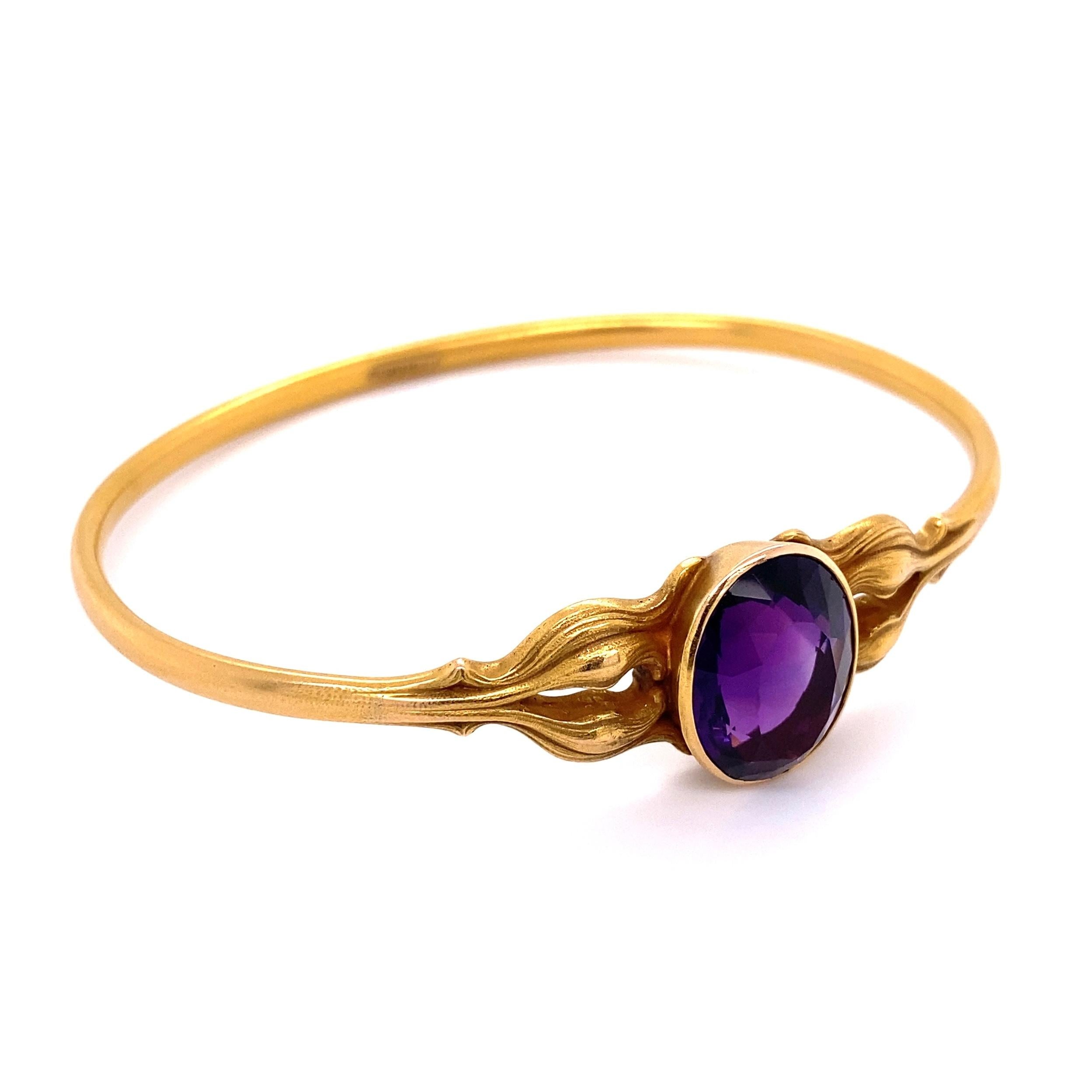 Simply Beautiful and Stylish Edwardian Shreve & Co Hand crafted Gold Bangle Bracelet, center securely set with an Amethyst and accented on either side with decorative designs. Hand crafted in 14 Karat yellow Gold. Marked SHREVE & CO 14K and