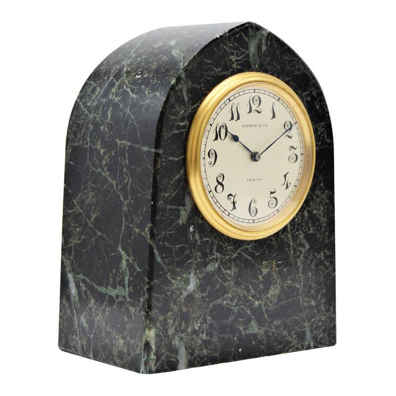 FACTORY / HOUSE: Shreve by Zenith 
STYLE / REFERENCE: Art Deco / Desk Clock
METAL / MATERIAL: Stone and Gilt Bronze
CIRCA / YEAR: 1930's
DIMENSIONS / SIZE: 5 Inches Tall
MOVEMENT / CALIBER: Manual Winding / 15 Jewels 
DIAL / HANDS: Silvered with