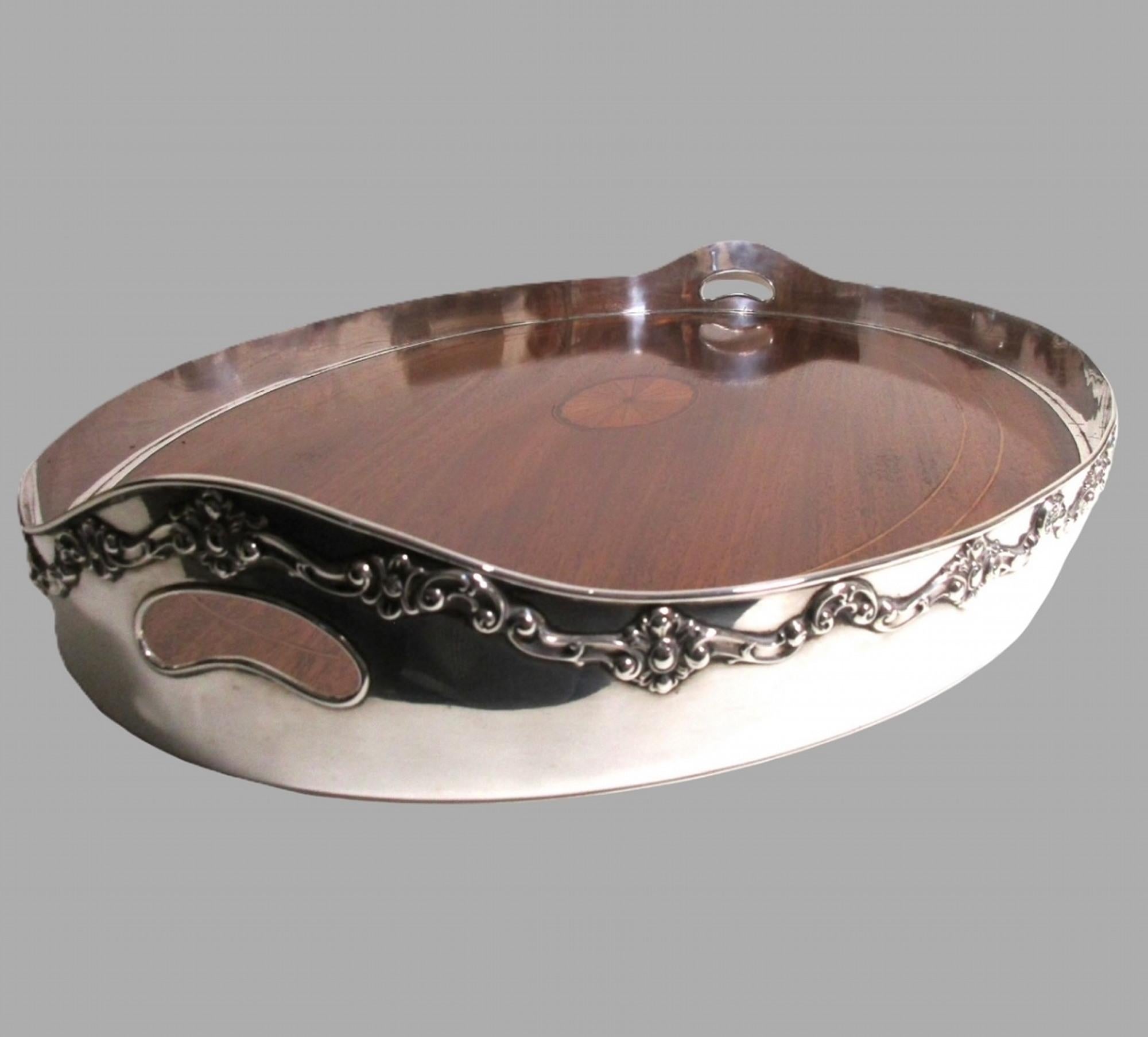 Produced by the famous Shreve & Co of San Francisco in the very early 20th century, this impressively large Sterling silver gallery tray is truly outstanding. Art Nouveau c1910

The two handled tray has a mahogany base with an intricate, beautifully