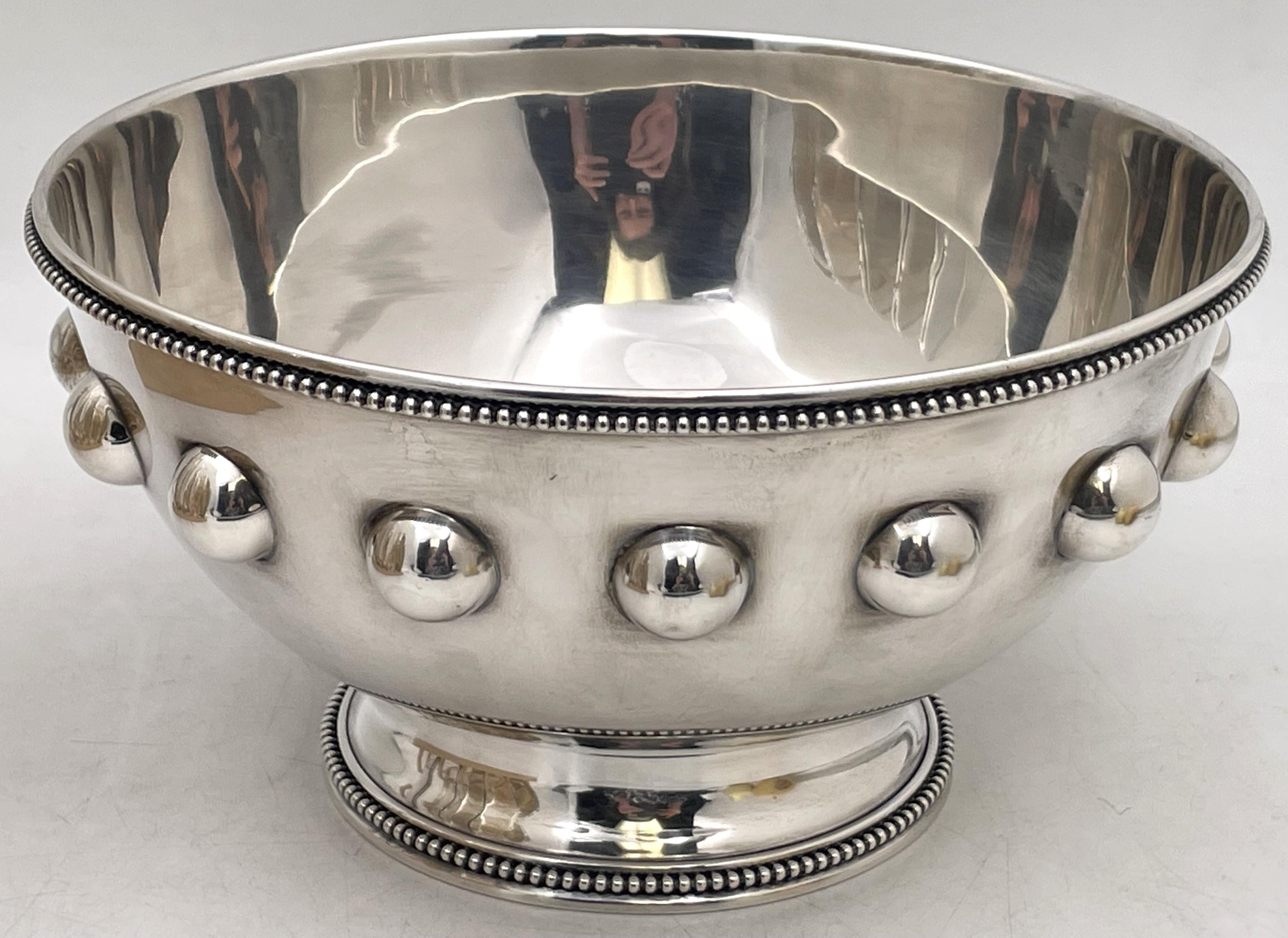 Shreve & Co. sterling silver bowl with raised circular motifs and with beaded rims, all in Mid-Century Modern style with an elegant, geometric design. It measures 9'' in diameter by 4 3/4'' in height, weighs 28.7 troy ounces, and bears hallmarks as