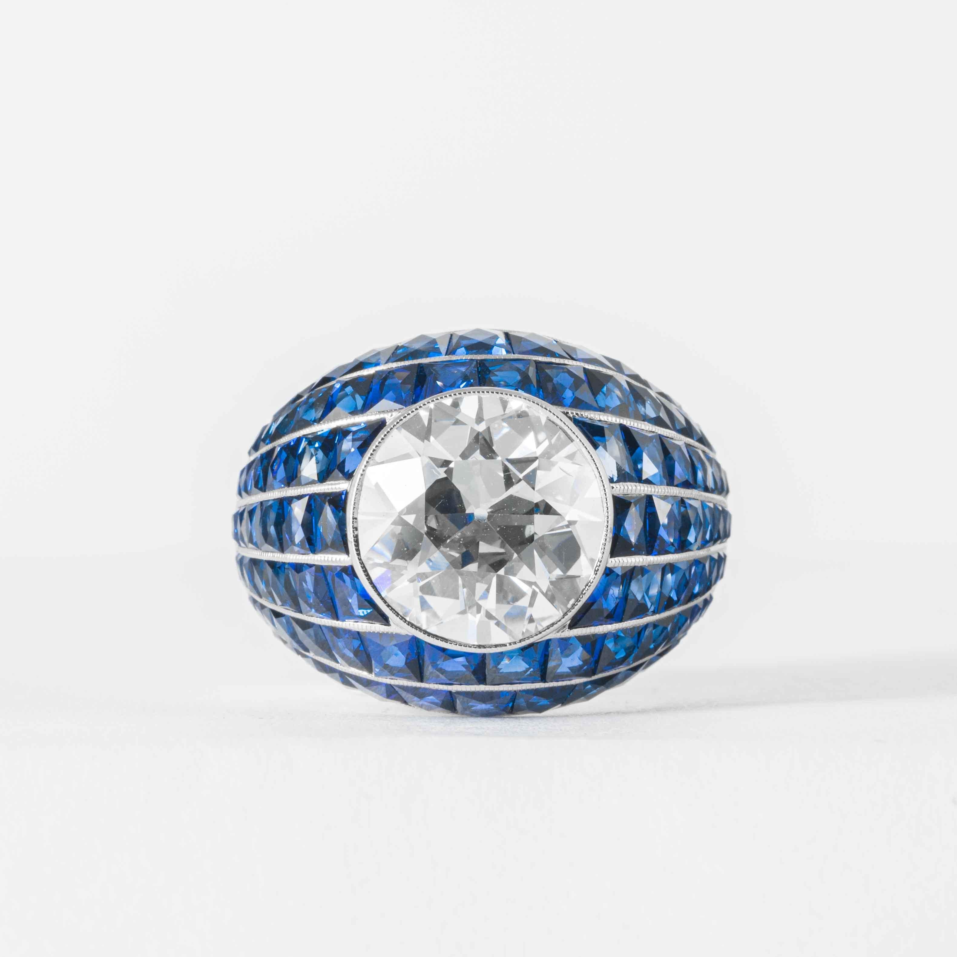 This elegant and classic diamond ring is offered by Shreve, Crump & Low. This 5.03 carat GIA certified J VS2 old European cut diamond is custom set in a handcrafted Shreve, Crump & Low blue sapphire Bombe style ring. Set with 7.73 carats of square