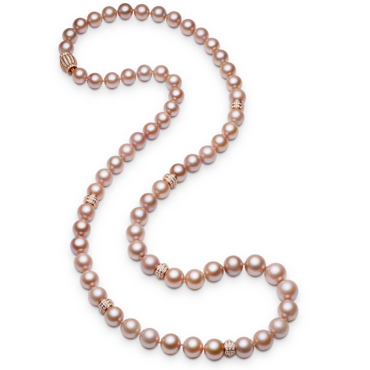 Stunning Pink cultured freshwater pearl necklace consisting of 65 pearls 11.50-14.50 millimeters with six 18 karat rose gold diamond rondelles and clasp, 34 inches in length.