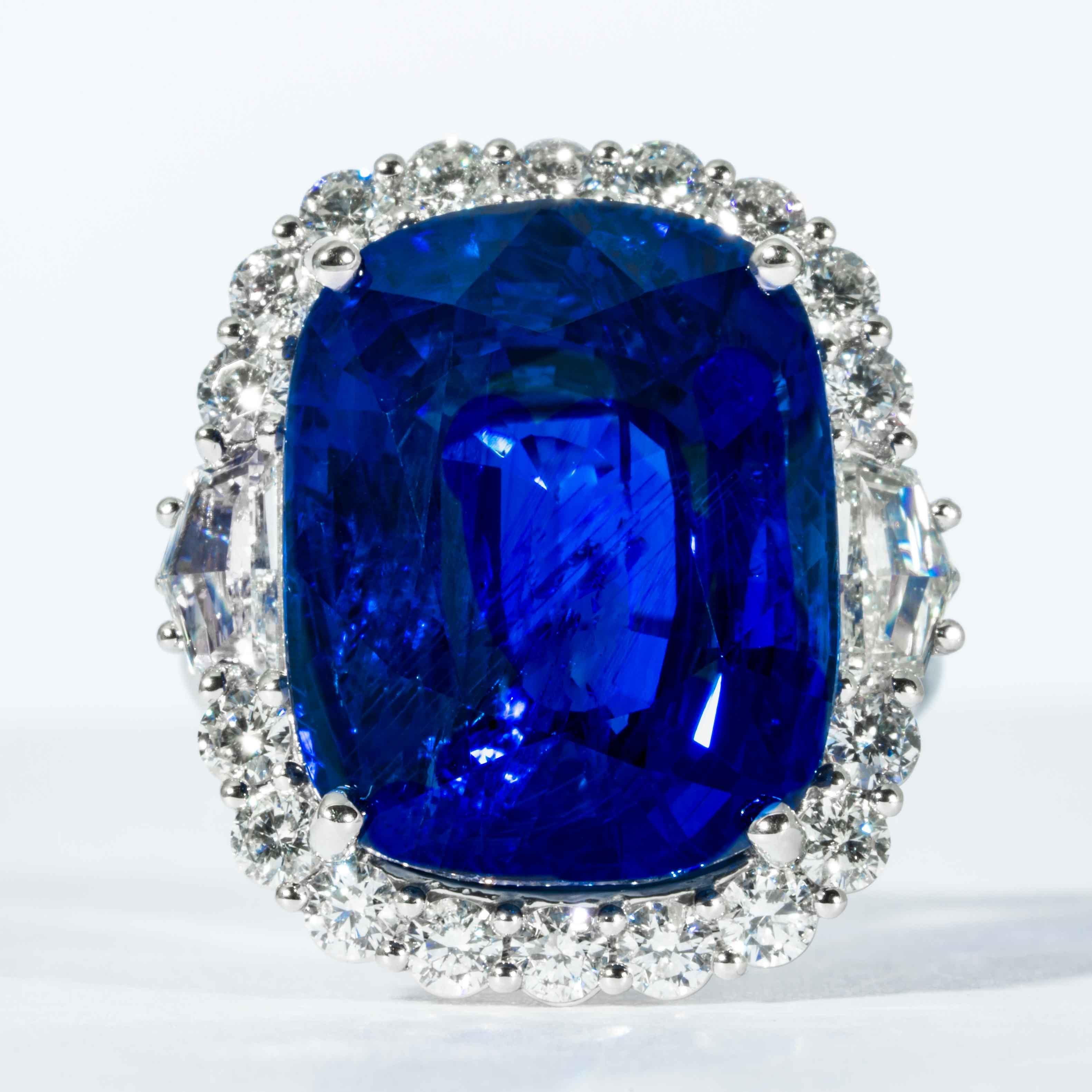 This sapphire and diamond cluster ring is offered by Shreve, Crump & Low.  This cushion cut Royal Blue Ceylon sapphire is custom set in a handcrafted Shreve, Crump & Low one-of-kind platinum ring, consisting of 1 majestic Royal blue cushion cut