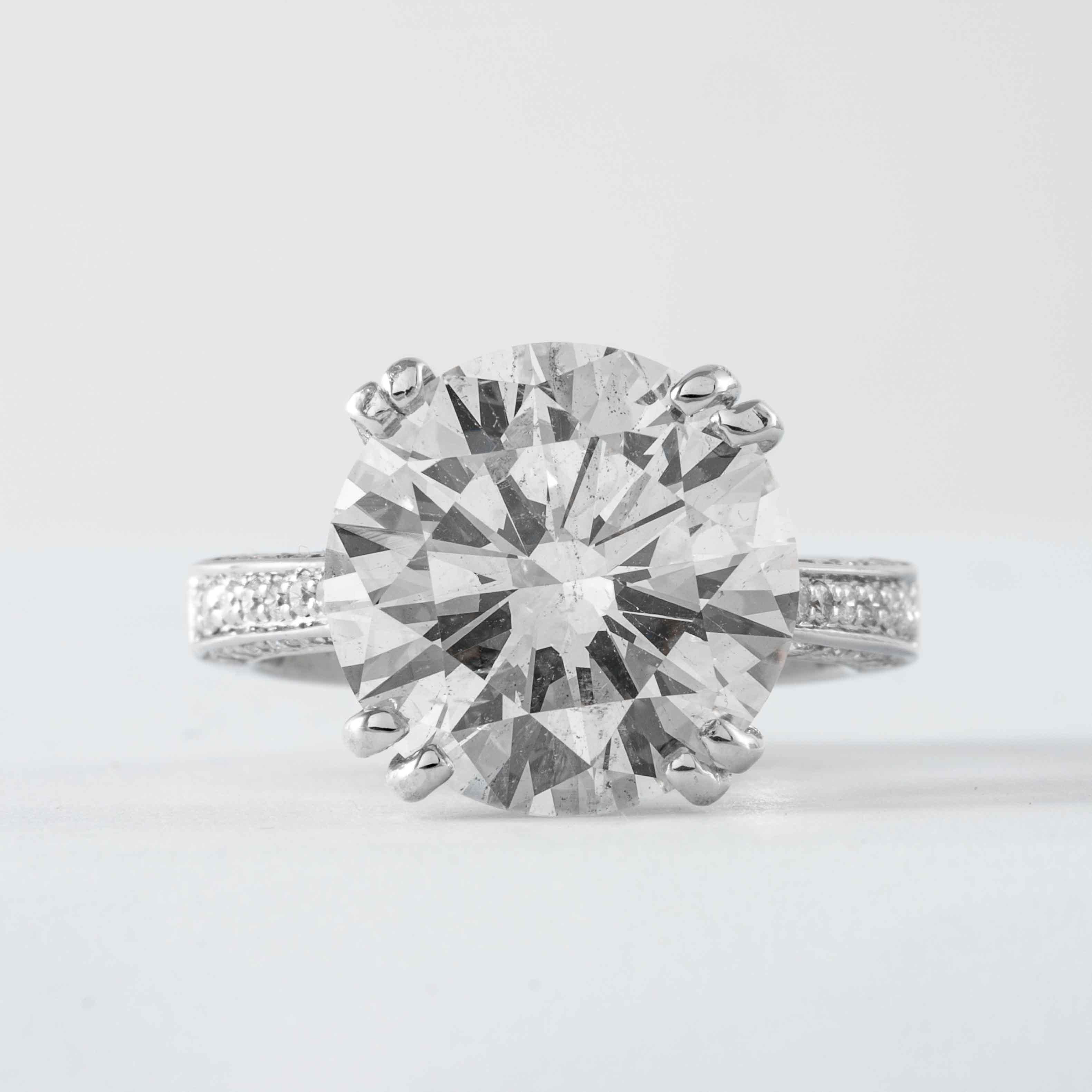 This platinum solitaire ring features 1 round brilliant cut diamond, weighing 8.30 carats with a respective color and clarity of J-K SI1-SI2. The diamond is set in a custom Shreve, Crump & Low classic 4-prong platinum ring with accenting diamond