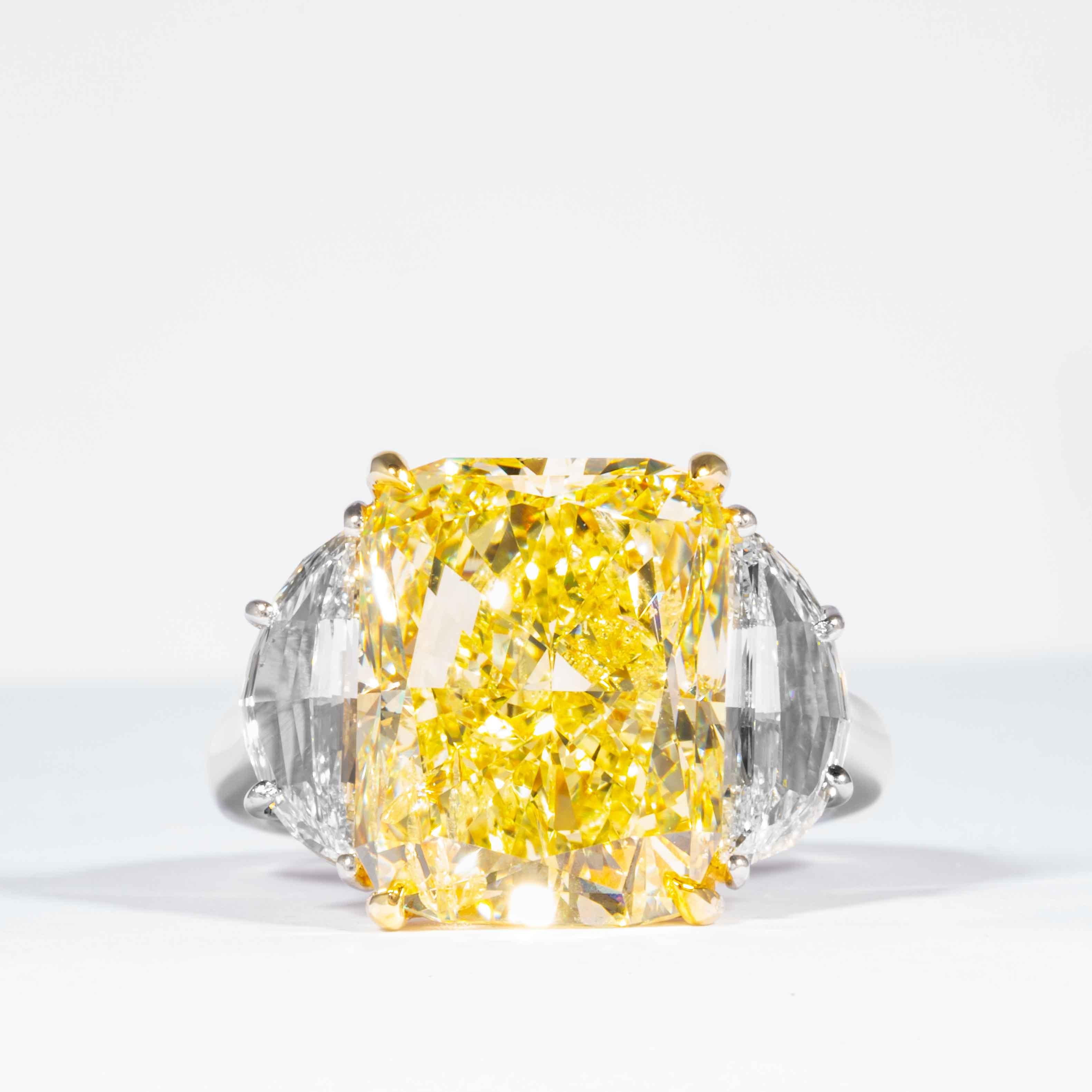 This fancy yellow radiant cut diamond is offered by Shreve, Crump & Low.  This fancy yellow radiant cut diamond is custom set in a handcrafted Shreve, Crump & Low platinum and 18 karat yellow gold 3 stone ring consisting of 1 radiant cut yellow