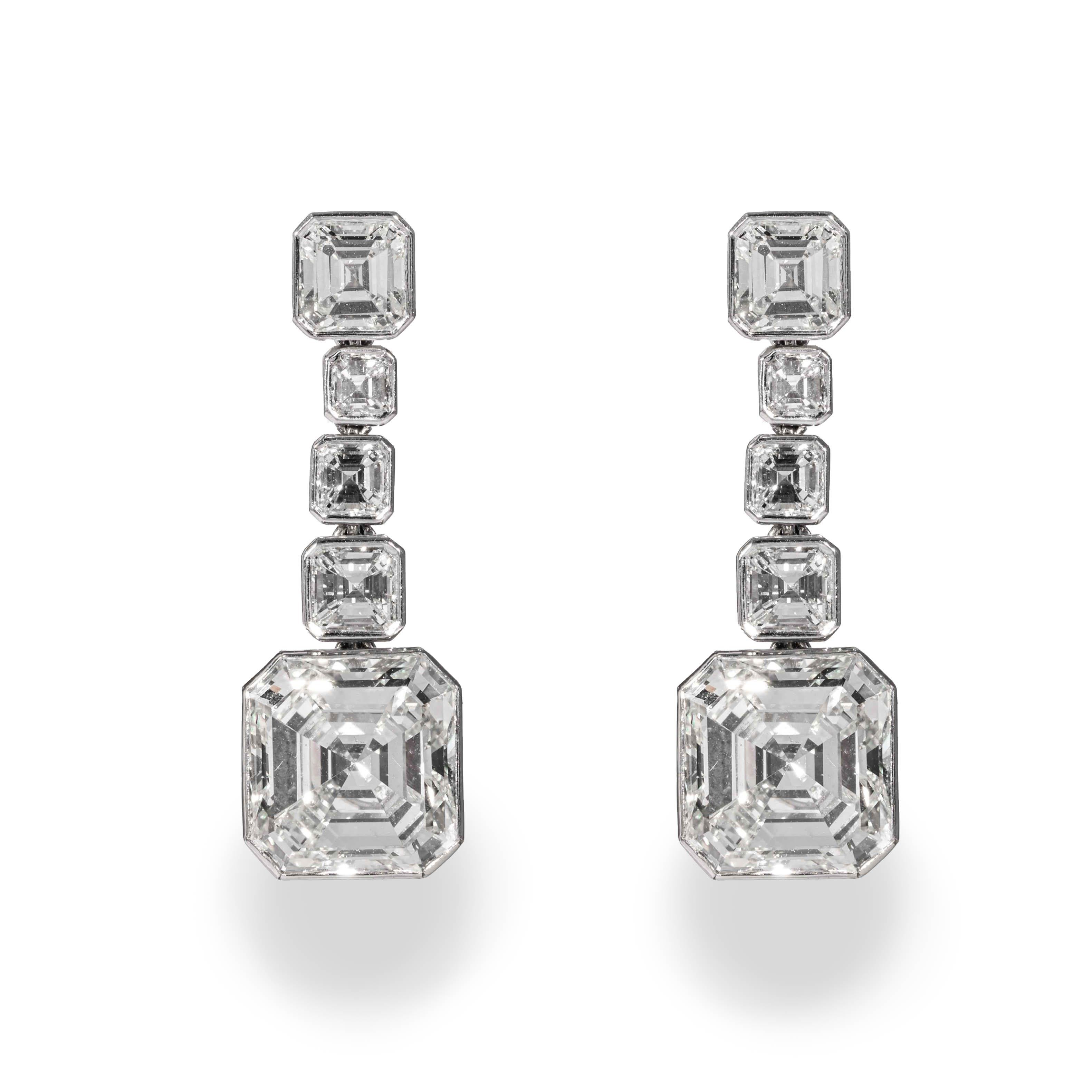 These earrings are offered by Shreve, Crump & Low. These spectacular diamond drop earrings incorporate two GIA certified Asscher cut diamonds, one weighing 5.06 carats with a color and clarity of J VS2 (GIA report no. 2201348478), the other weighs