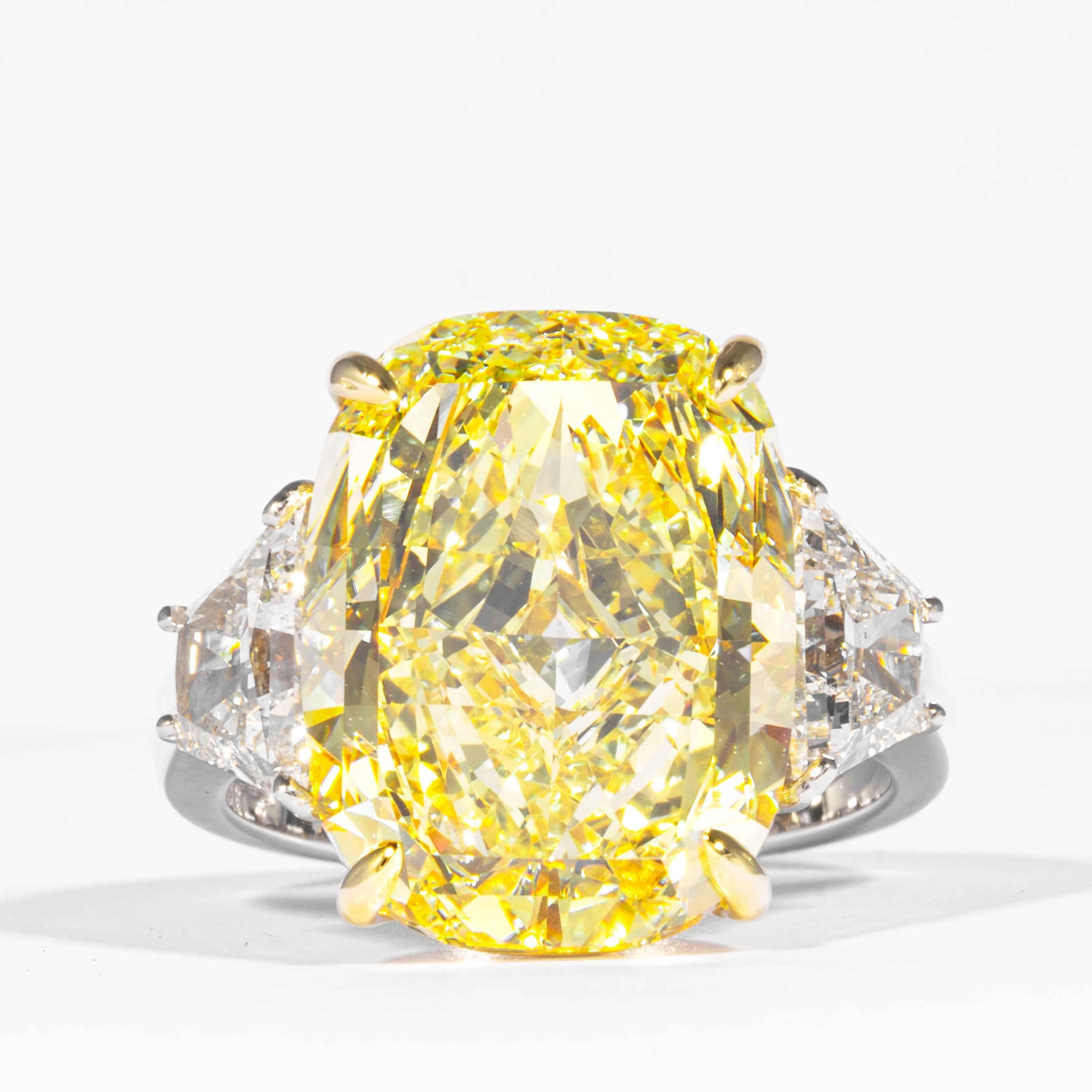 This fancy yellow cushion cut diamond is offered by Shreve, Crump & Low.  This fancy yellow cushion cut diamond is custom set in a handcrafted Shreve, Crump & Low platinum and 18 karat yellow gold 3 stone ring consisting of 1 cushion cut yellow