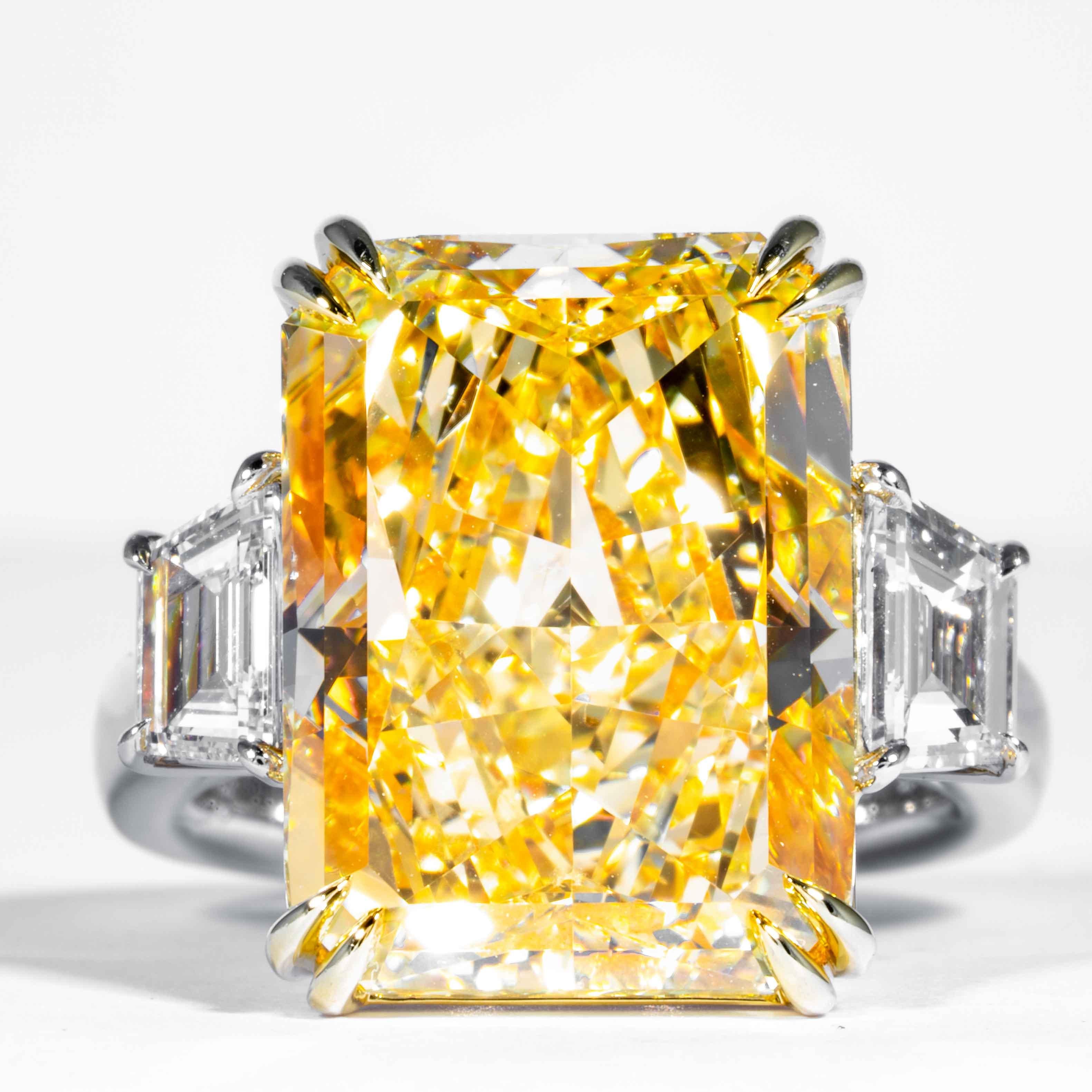 This important fancy yellow radiant diamond is offered by Shreve, Crump & Low.  It is custom set in a handcrafted Shreve, Crump & Low Platinum and 18 karat yellow gold 3 stone ring consisting of 1 radiant cut yellow diamond weighing 17.01 carats