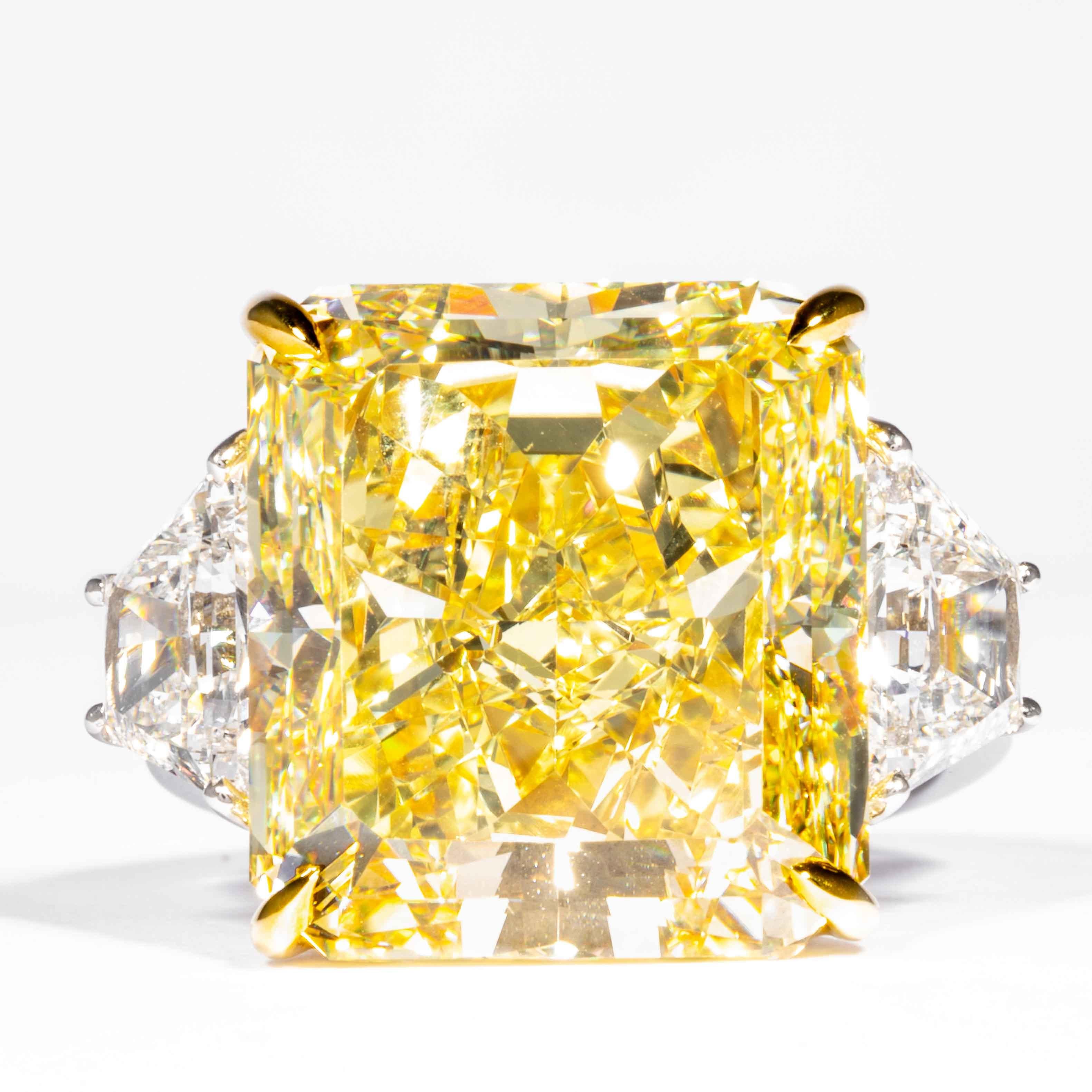 This important and rare fancy yellow radiant diamond is offered by Shreve, Crump & Low. It is custom set in a handcrafted Shreve, Crump & Low Platinum and 18 karat yellow gold 3 stone ring consisting of 1 radiant cut yellow diamond weighing 20.24