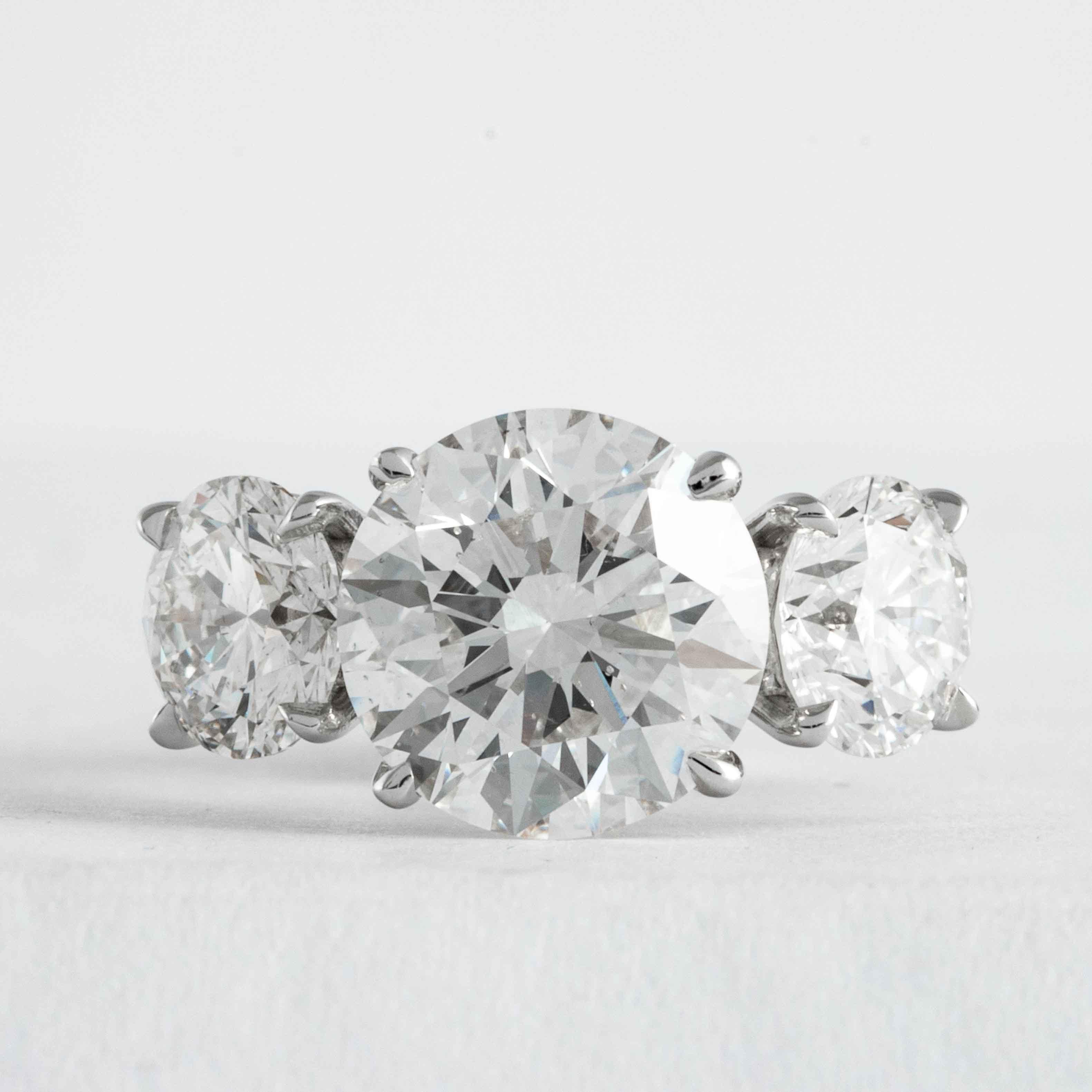 This elegant and classic diamond ring is offered by Shreve, Crump & Low. This 3.51 carat H SI1 round brilliant cut diamond is custom set in a handcrafted Shreve, Crump & Low platinum 3-stone ring. The 3.51 carat center diamond is accented by two