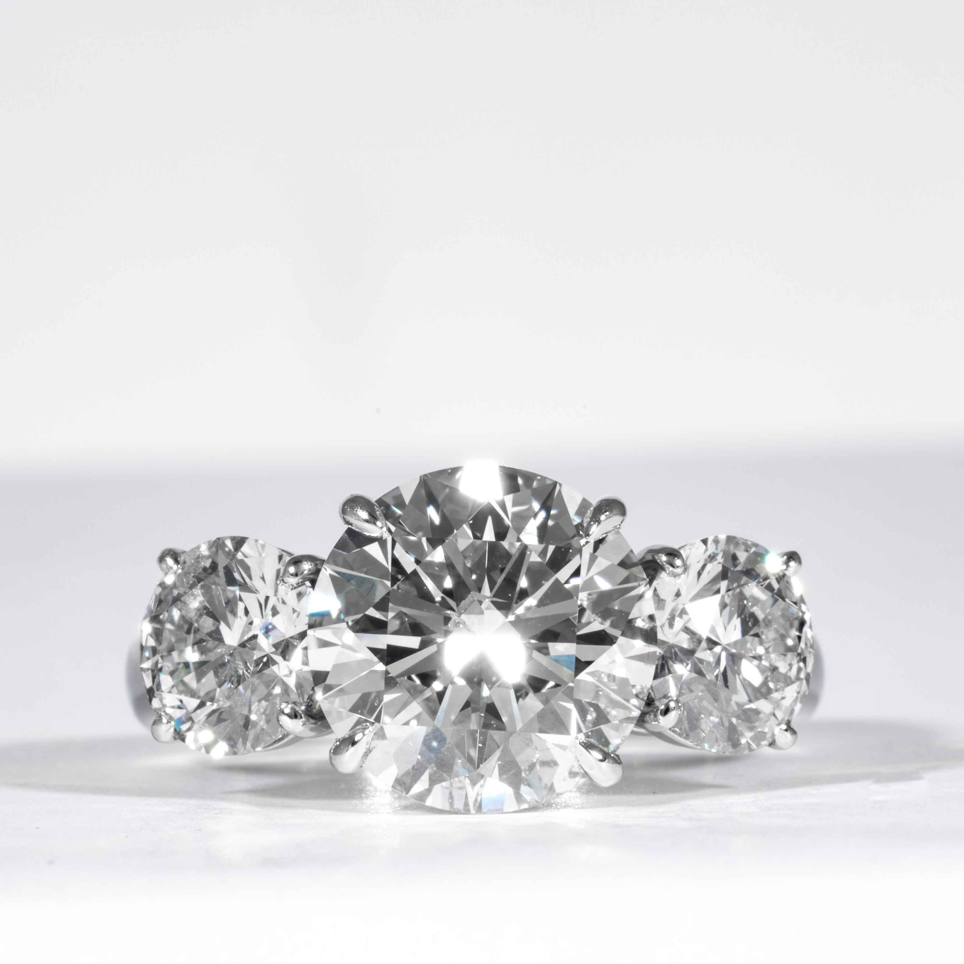This elegant and classic diamond ring is offered by Shreve, Crump & Low. This 3.99 carat GIA Certified J SI1 round brilliant cut diamond measuring 10.17 - 10.20 x 6.25 mm is custom set in a handcrafted Shreve, Crump & Low platinum 3-stone ring. The