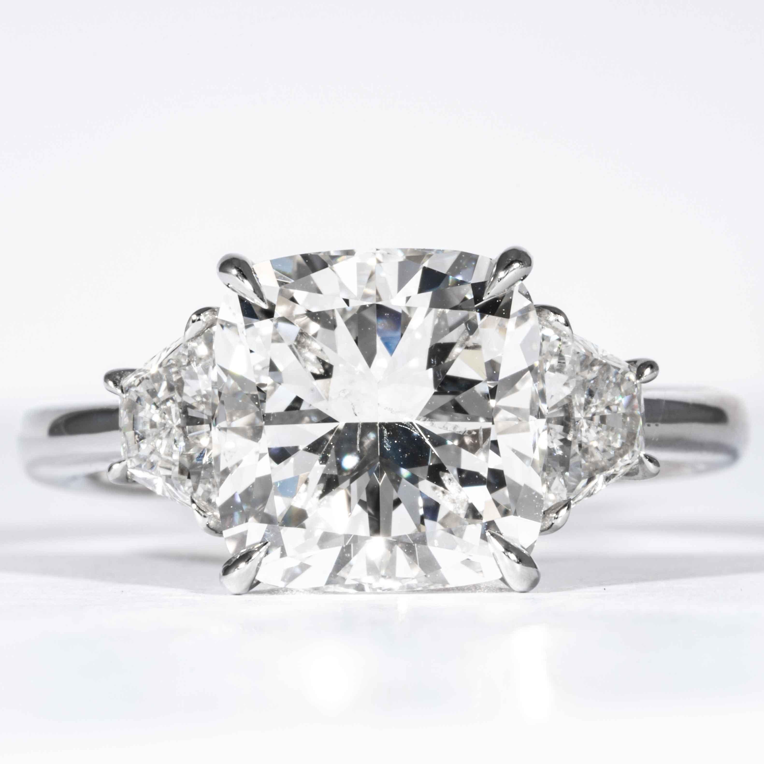 This 3-Stone diamond ring is offered by Shreve, Crump & Low. This 4.05 carat GIA Certified G SI2 cushion cut diamond measuring 9.33 x 9.11 x 6.11 mm is custom set in a handcrafted Shreve, Crump & Low platinum 3-stone ring. The 4.05 carat center