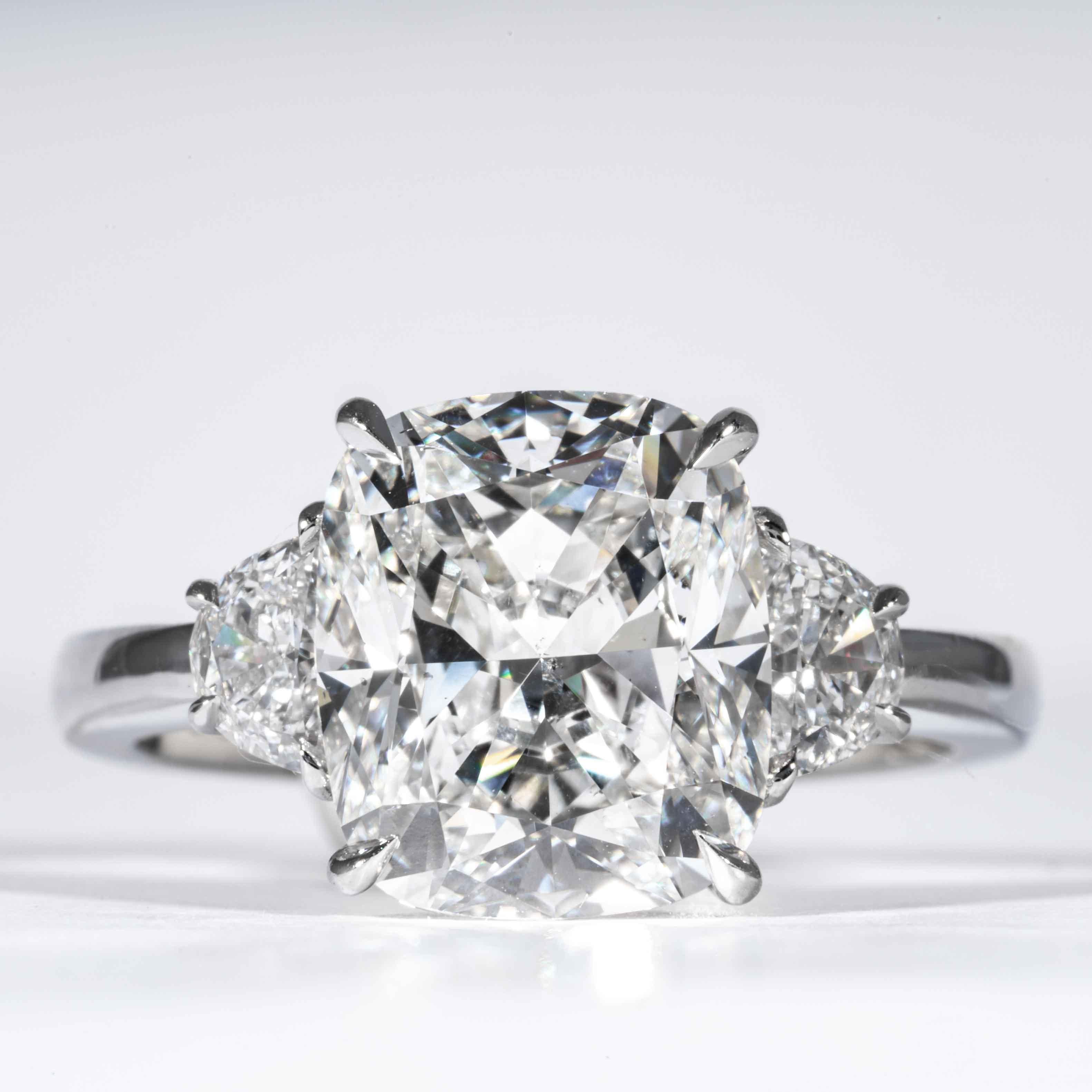 This 3-Stone diamond ring is offered by Shreve, Crump & Low. This 4.10 carat GIA Certified E SI1 cushion cut diamond measuring 10.56 x 9.00 x 5.68 mm is custom set in a handcrafted Shreve, Crump & Low platinum 3-stone ring. The 4.10 carat center