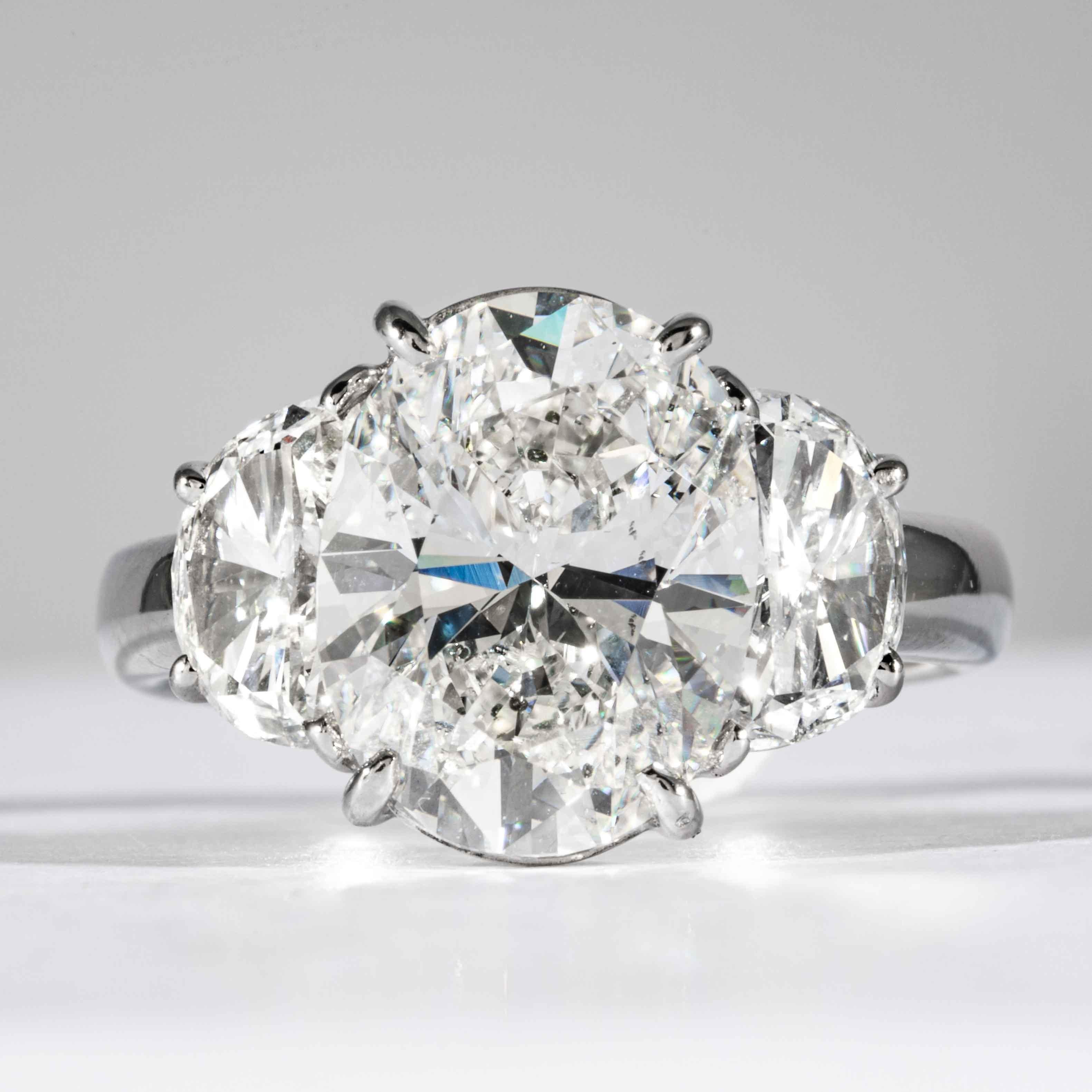 This oval cut diamond ring is offered by Shreve, Crump & Low. This 4.12 carat GIA certified G SI1 Oval cut diamond measuring 11.75 x 9.02 x 5.68mm is custom set in a handcrafted Shreve, Crump & Low platinum 3-stone ring. The 4.12 carat center