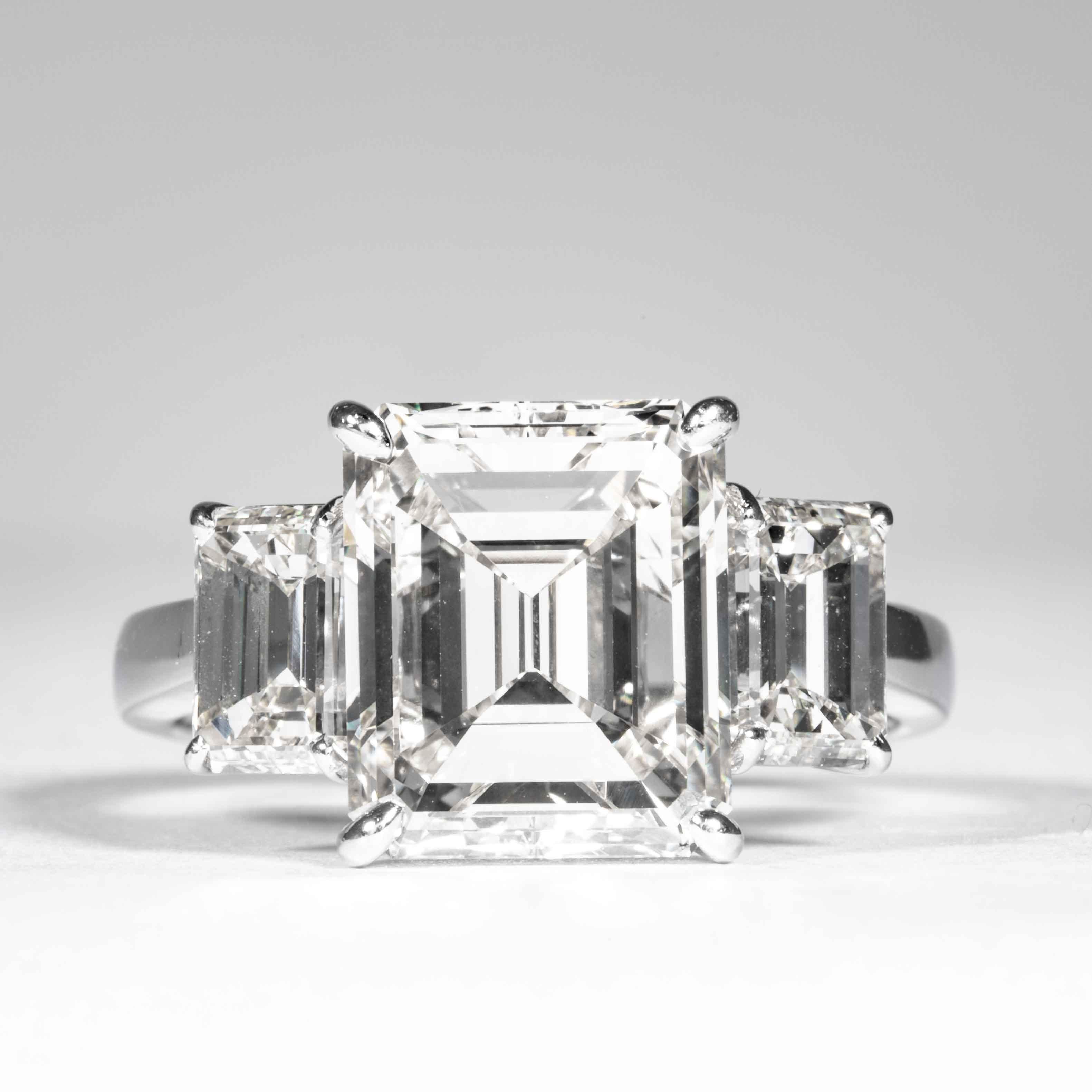 This 3-Stone diamond ring is offered by Shreve, Crump & Low. This 5.05 carat GIA Certified J VVS2 emerald cut diamond measuring 10.85 x 9.08 x 5.72 mm is custom set in a handcrafted Shreve, Crump & Low platinum 3-stone ring. The 5.05 carat emerald