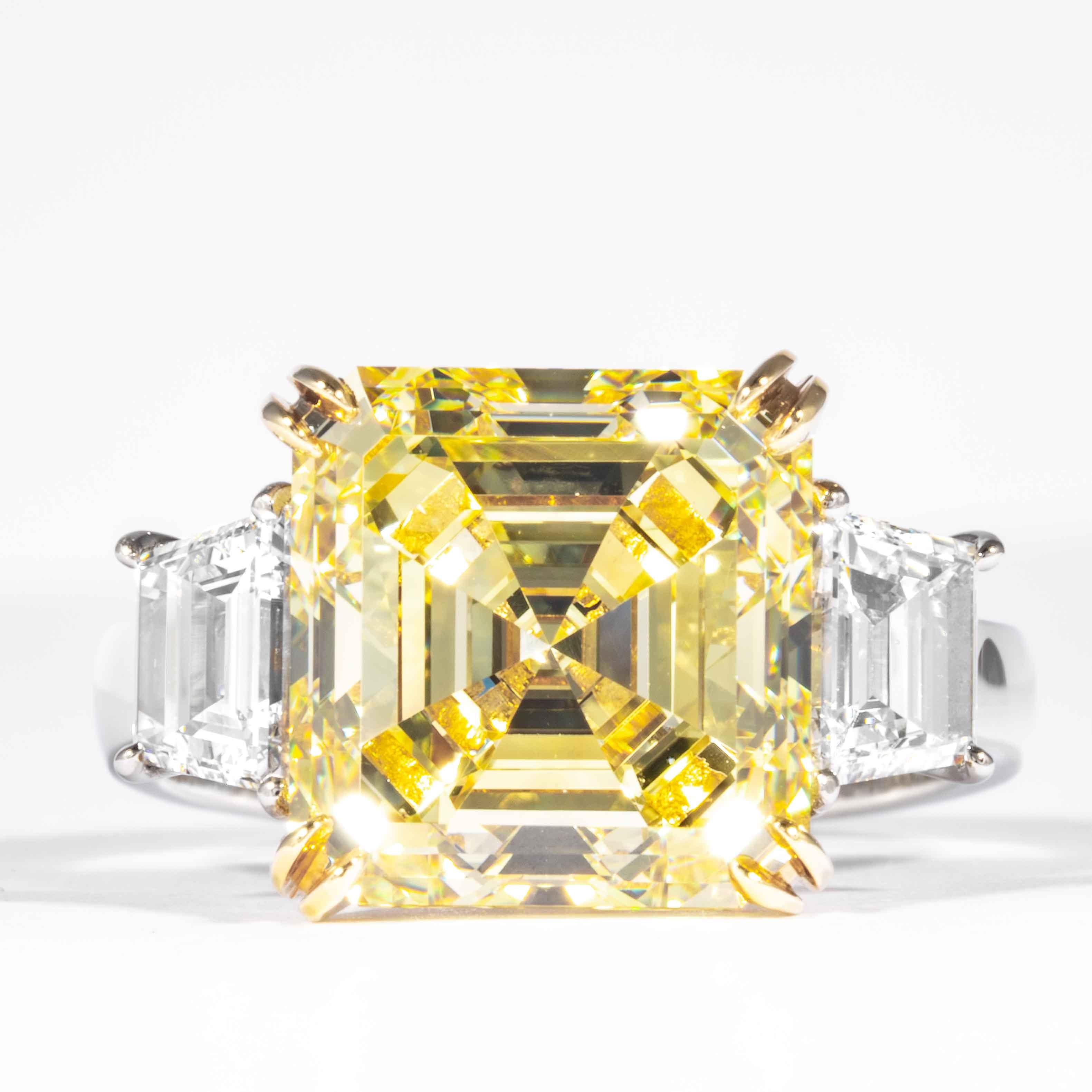 This fancy yellow square emerald cut diamond is offered by Shreve, Crump & Low. This fancy yellow square emerald cut diamond is custom set in a handcrafted Shreve, Crump & Low platinum and 18 karat yellow gold 3 stone ring consisting of 1 square