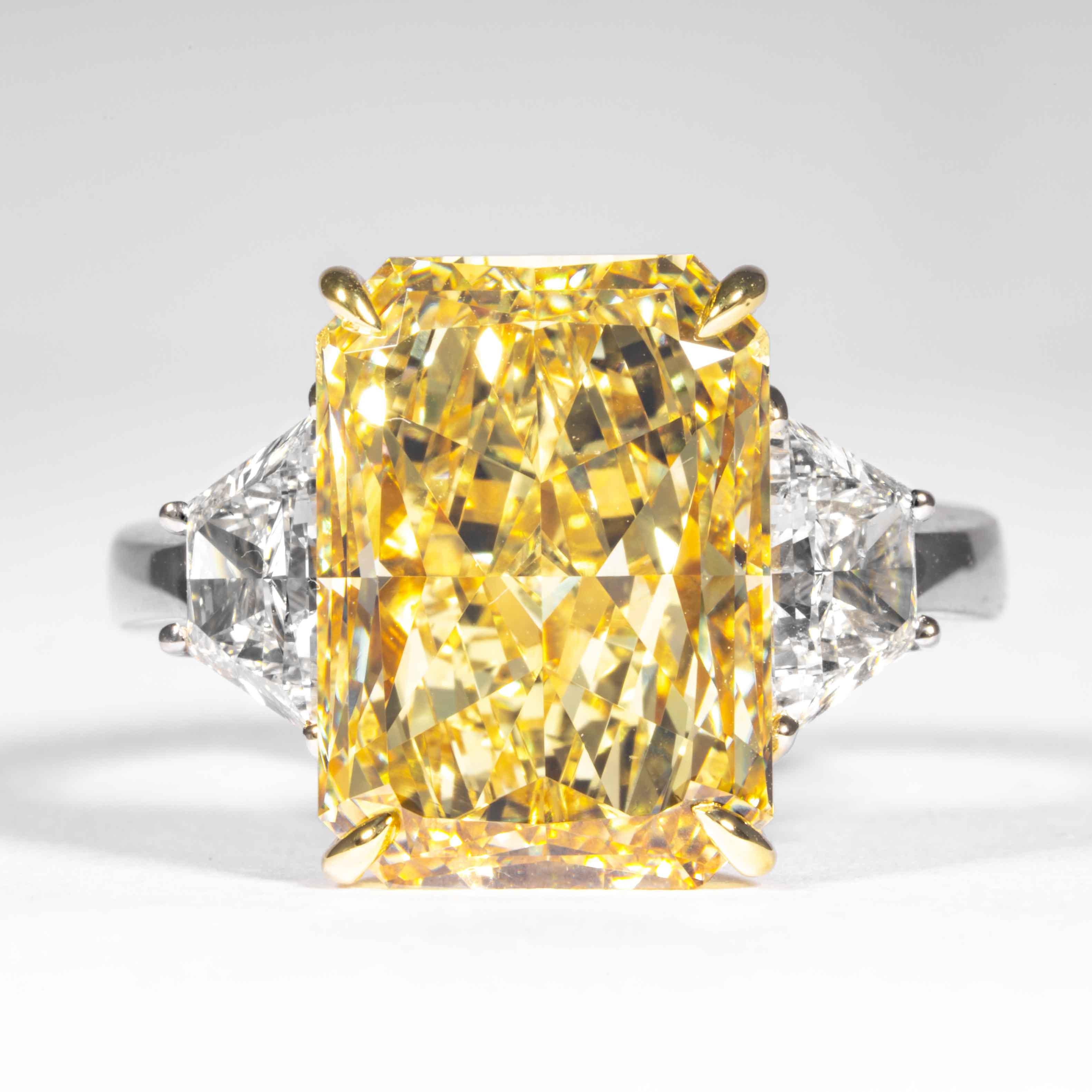 This fancy yellow elongated radiant cut diamond is offered by Shreve, Crump & Low.  This fancy yellow radiant cut diamond is custom set in a handcrafted Shreve, Crump & Low platinum and 18 karat yellow gold 3 stone ring consisting of 1 radiant cut