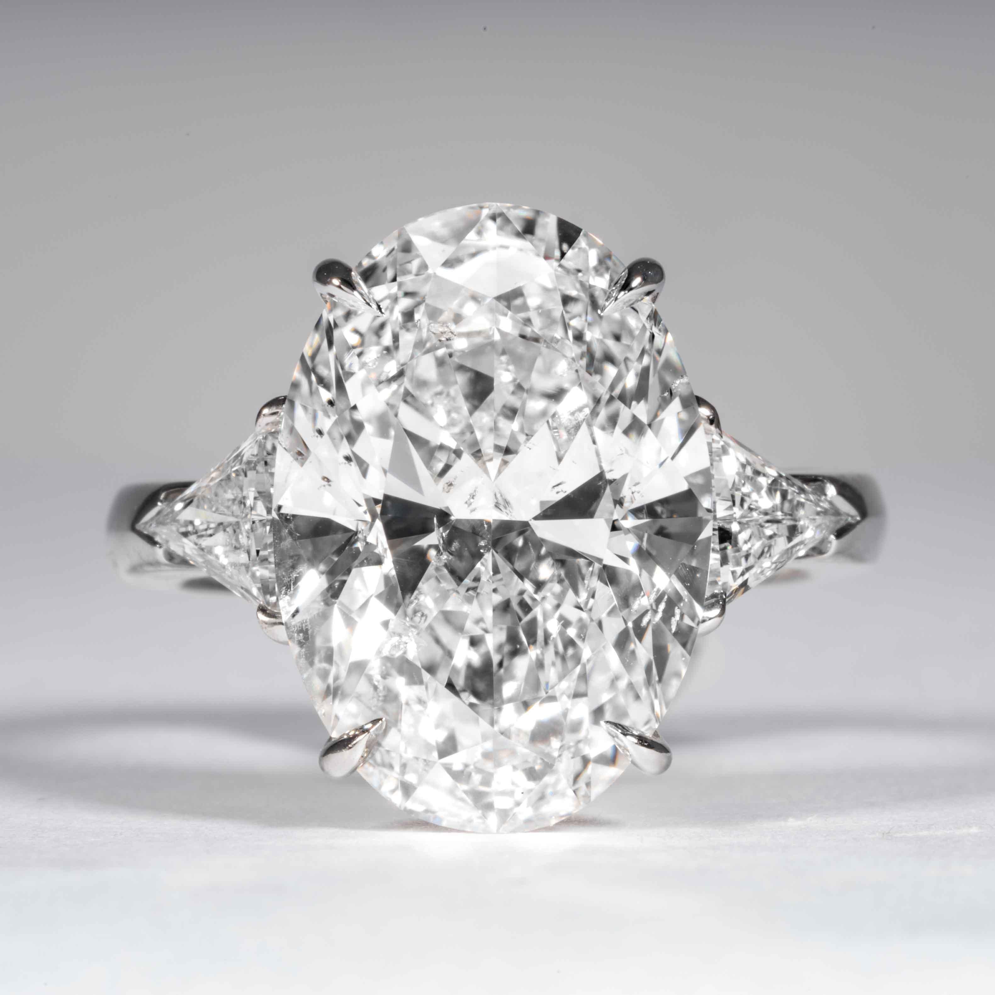 This finely cut oval diamond ring is offered by Shreve, Crump & Low. This 9.08 carat GIA Certified F SI2 Oval cut diamond measuring 16.82 x 11.76 x 7.12mm is custom set in a handcrafted Shreve, Crump & Low platinum 3-stone ring. The 9.08 carat